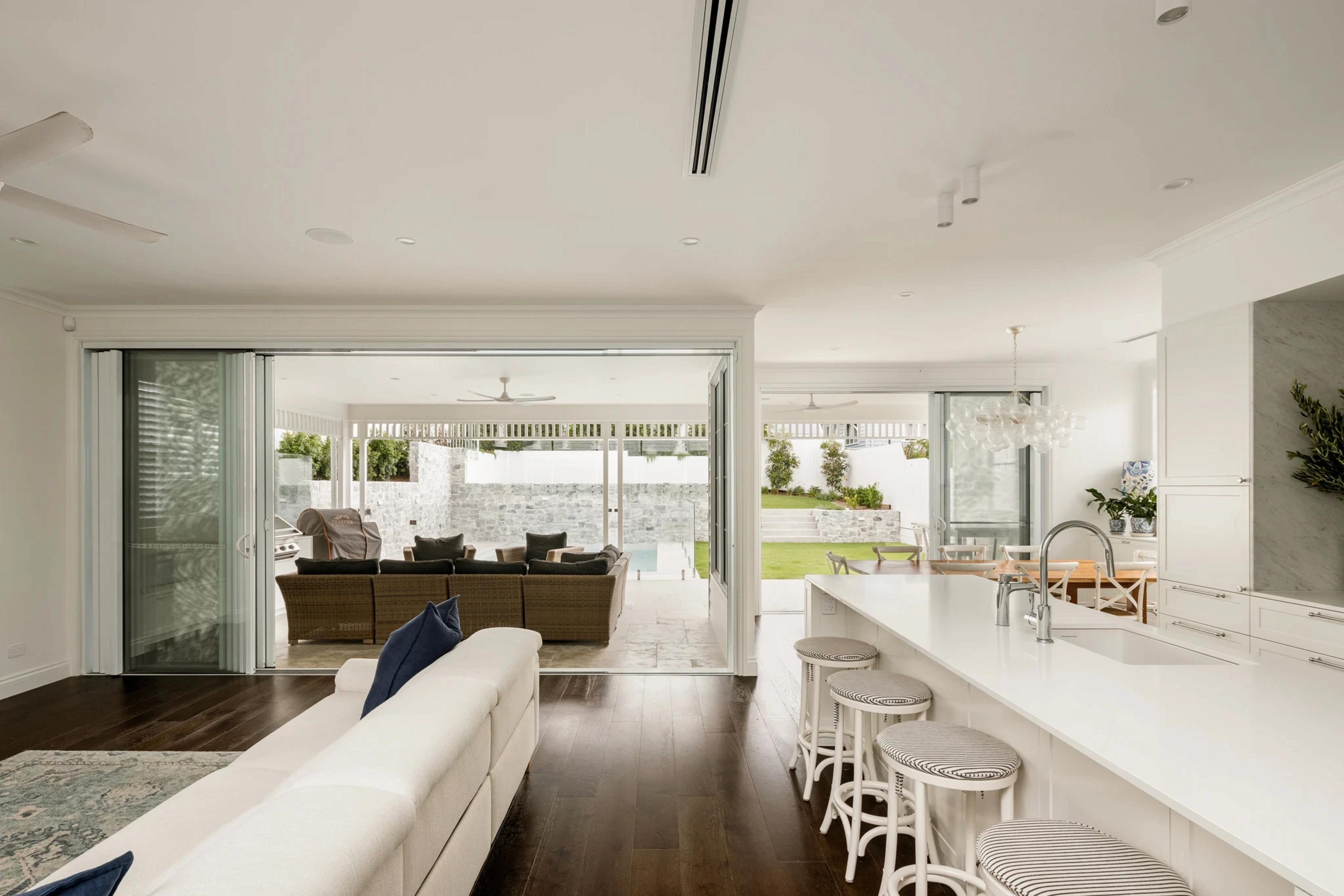 Open plan living room and kitchen looking out to pool