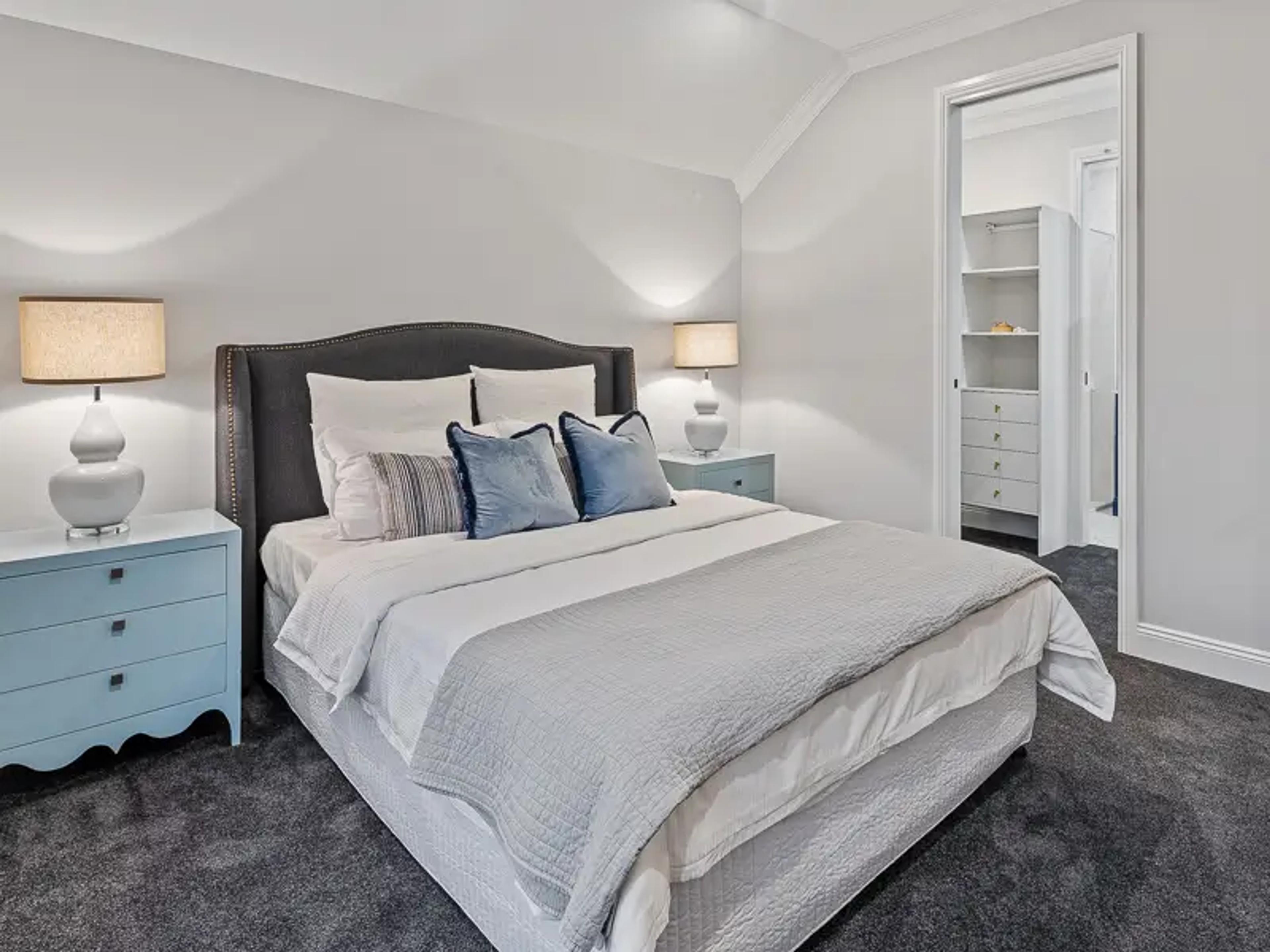 Main bedroom with upholstered bed and walk in wardrobe