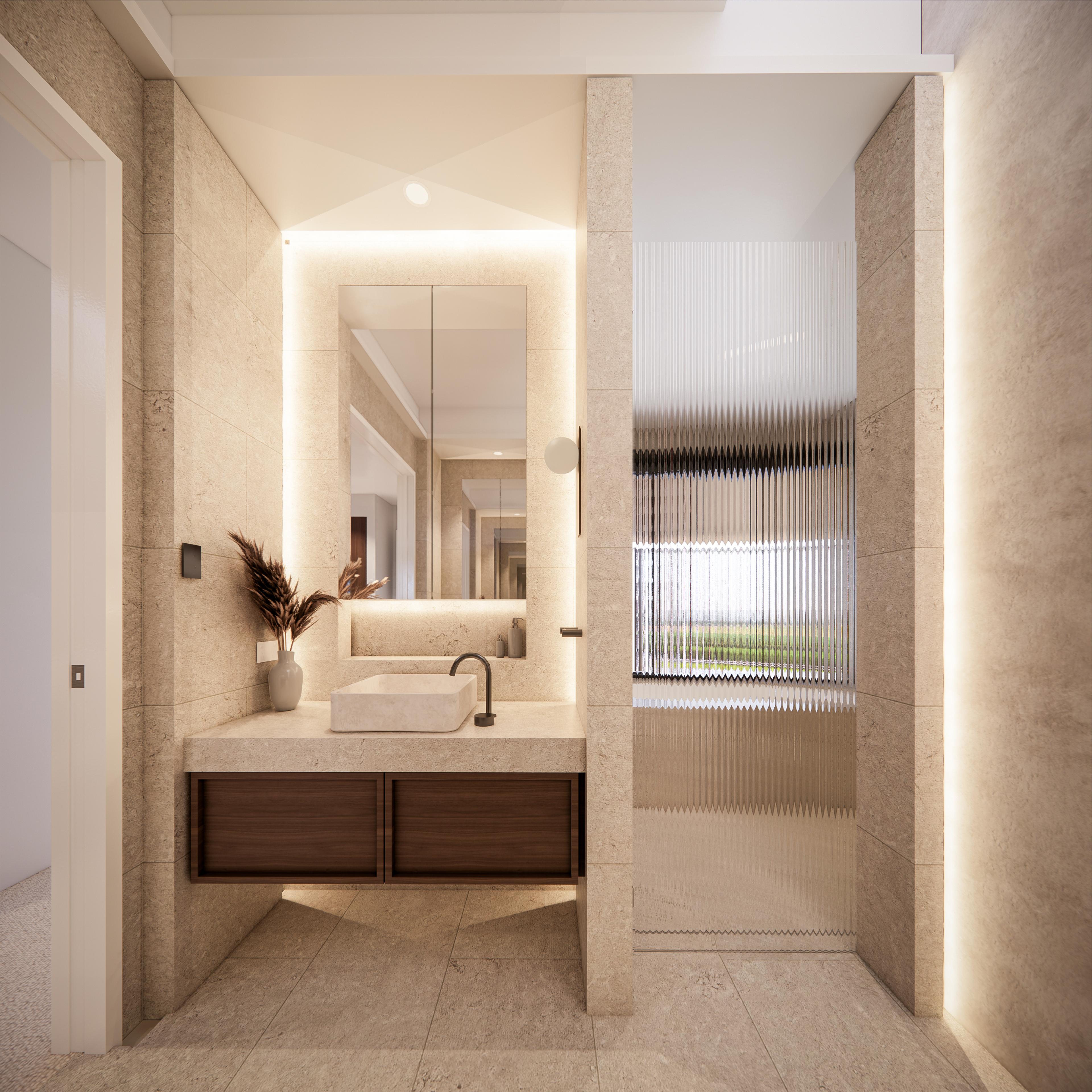 Ensuite vanity in warm stone with backlit mirror, walnut drawers and a fluted glass shower to a garden window