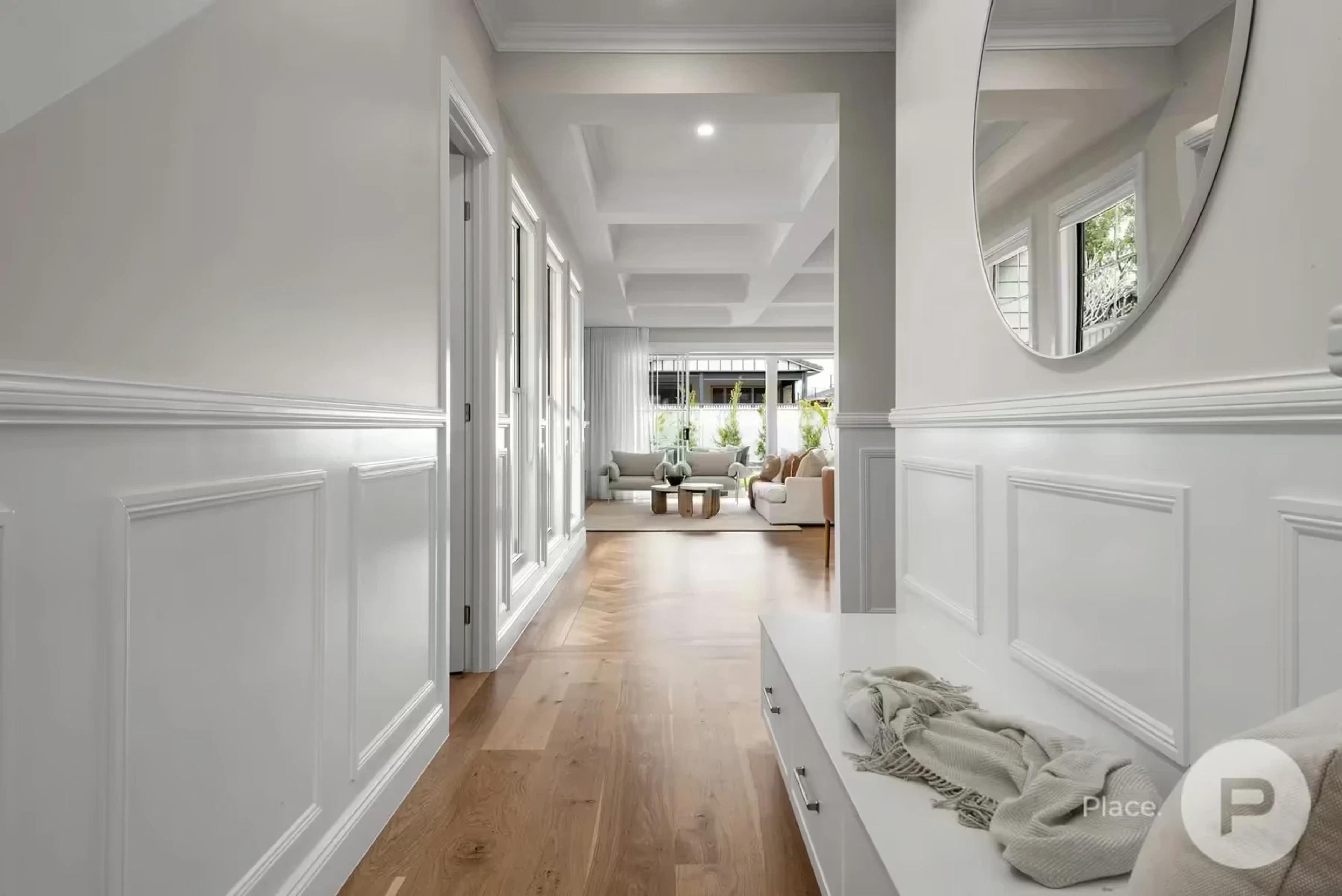 Panelled entry hallway with timber floor and bench seat