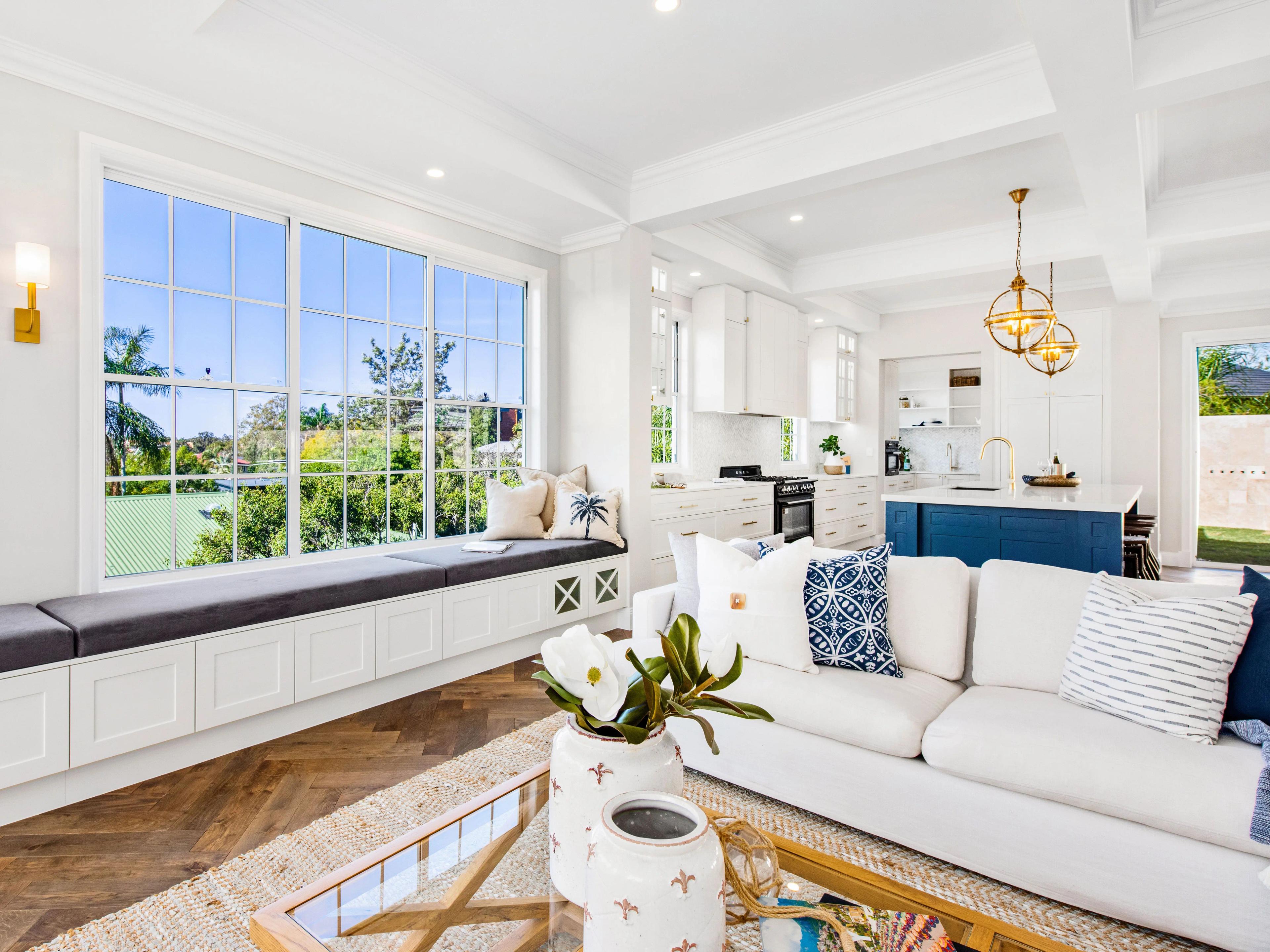 Open living room with window seat and blue kitchen island
