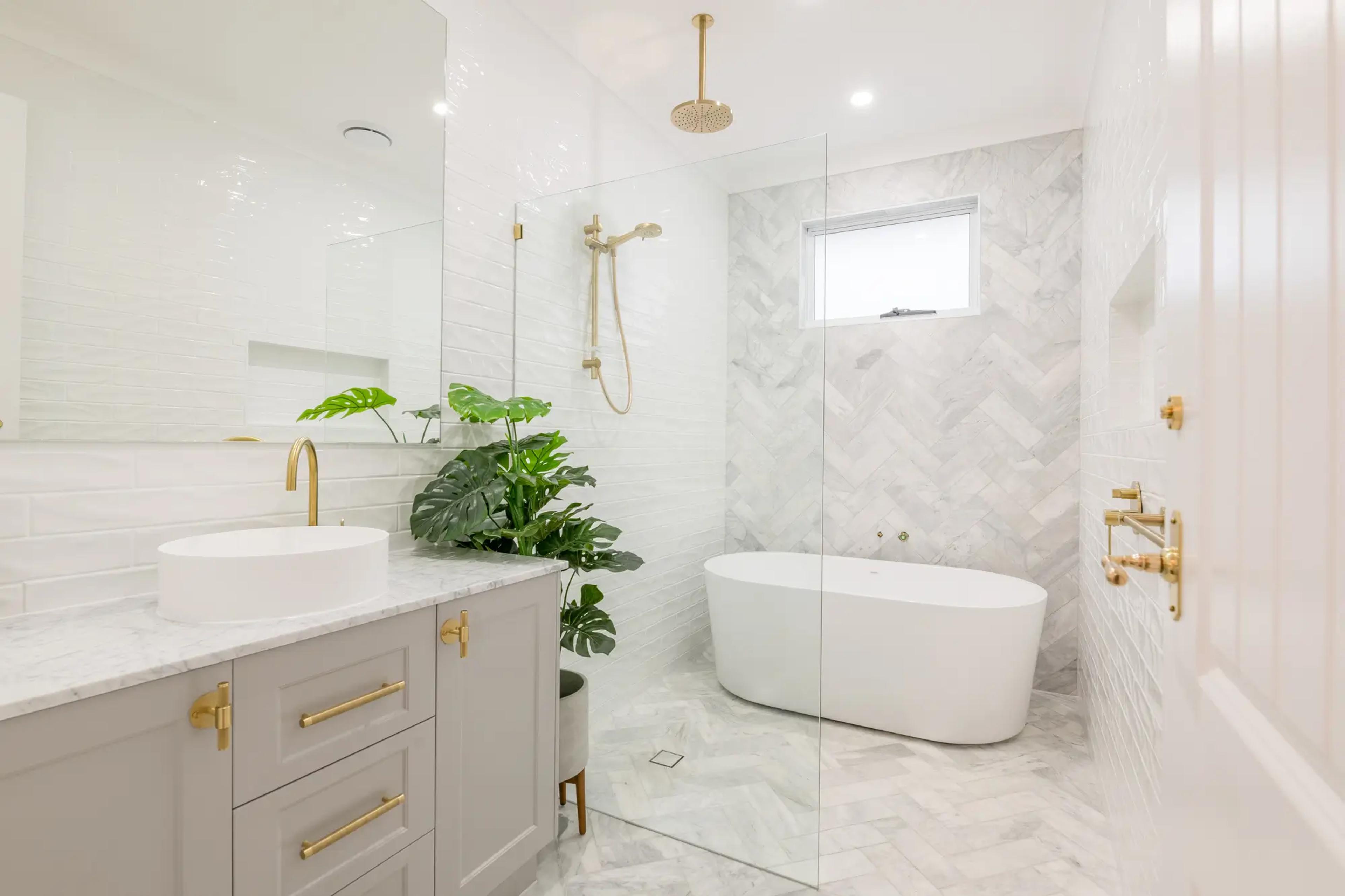 Bathroom with freestanding tub and herringbone tiled shower