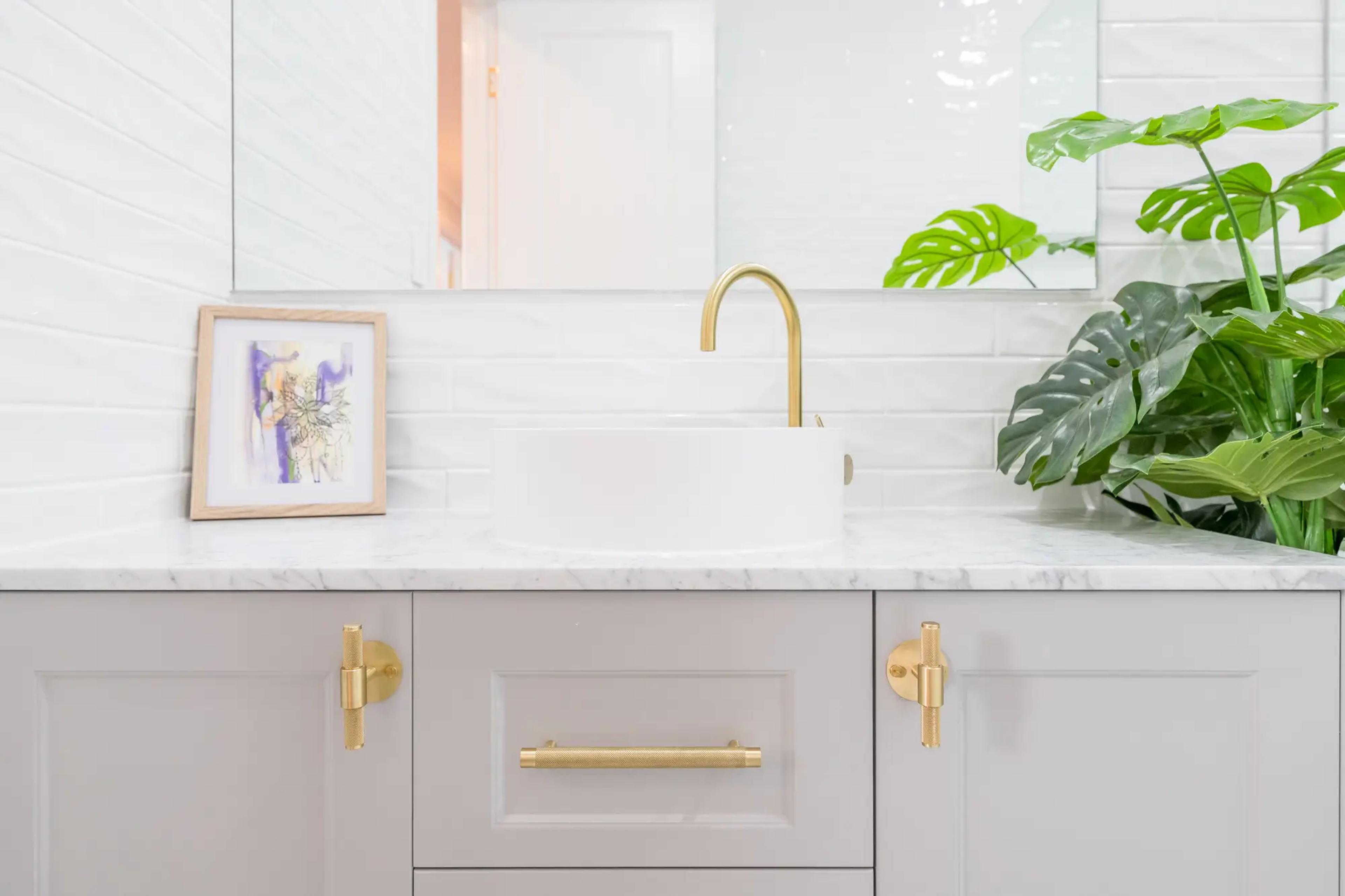 Vanity with round basin, brass tap and marble top