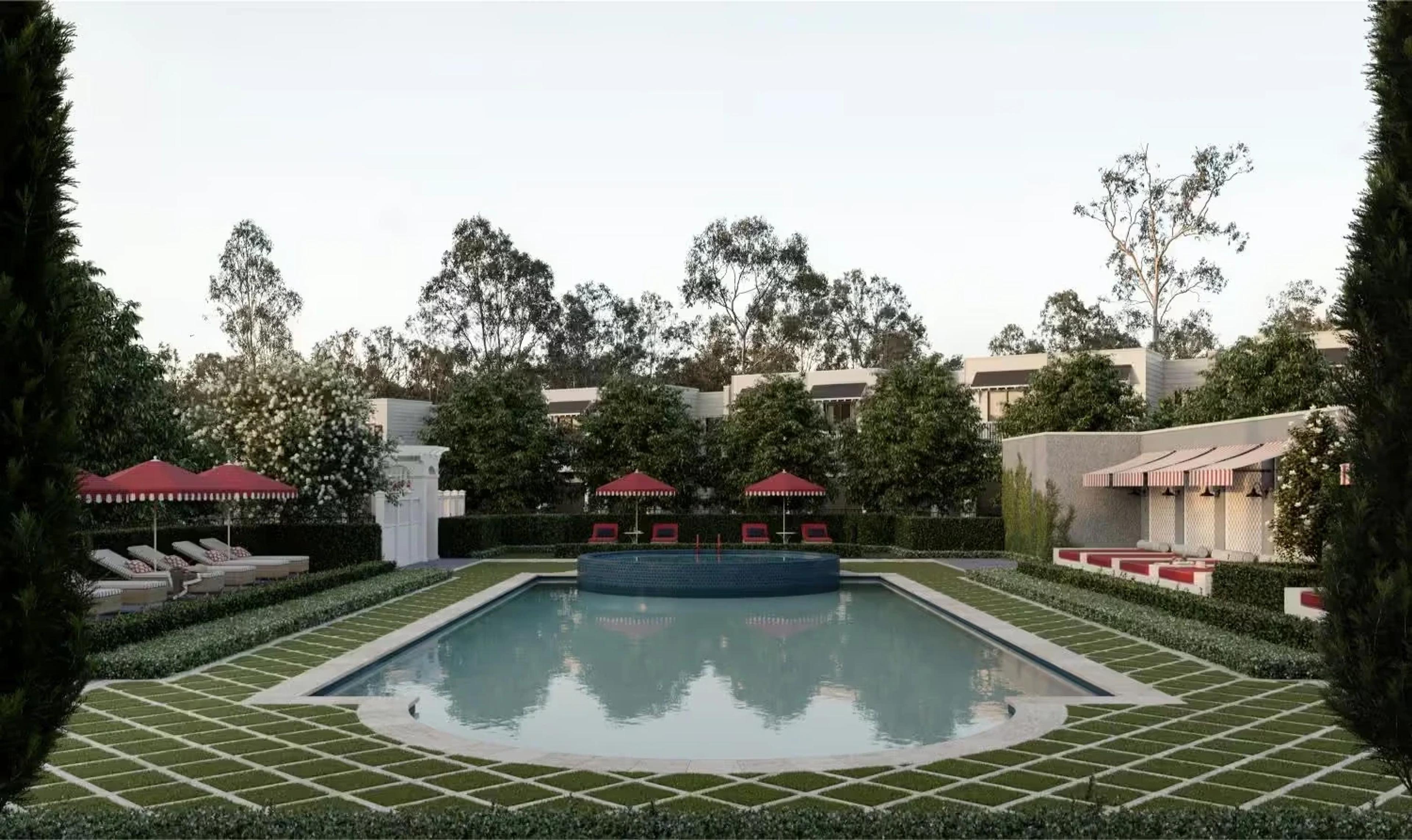 Landscaped courtyard pool with lounges and striped umbrellas