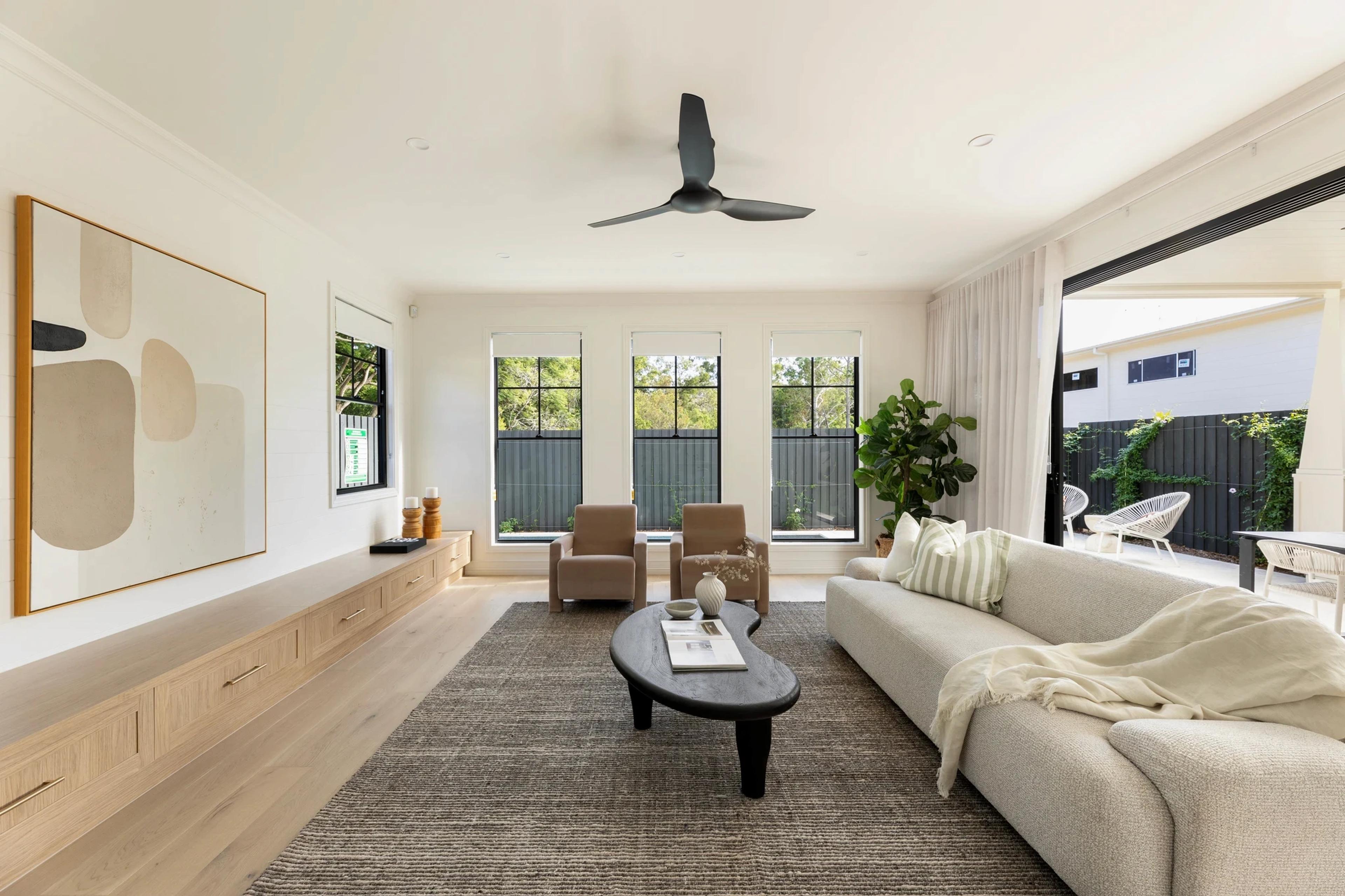 Living room opening to outdoor terrace through large glass doors