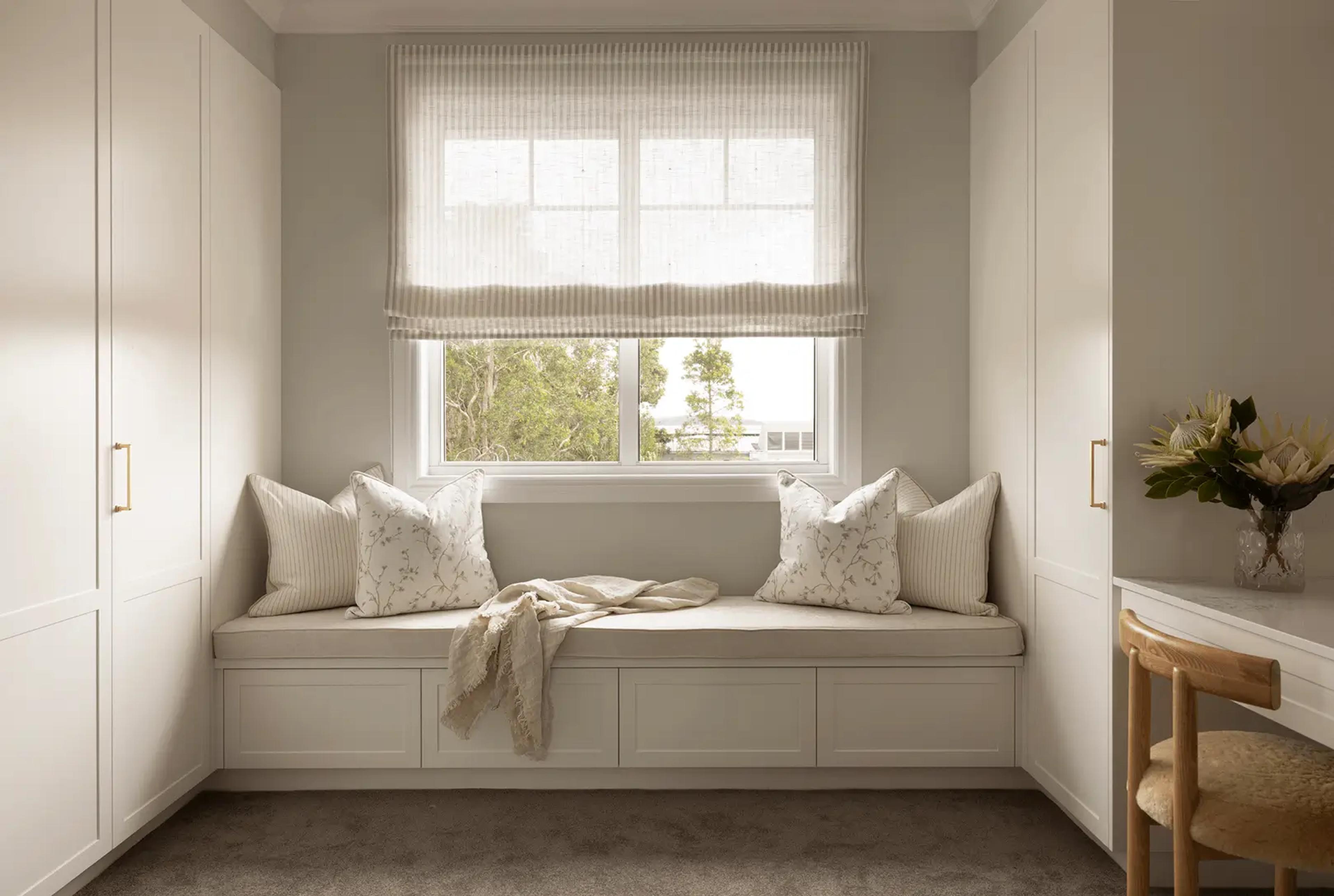 Built-in window seat nook with cushions and joinery