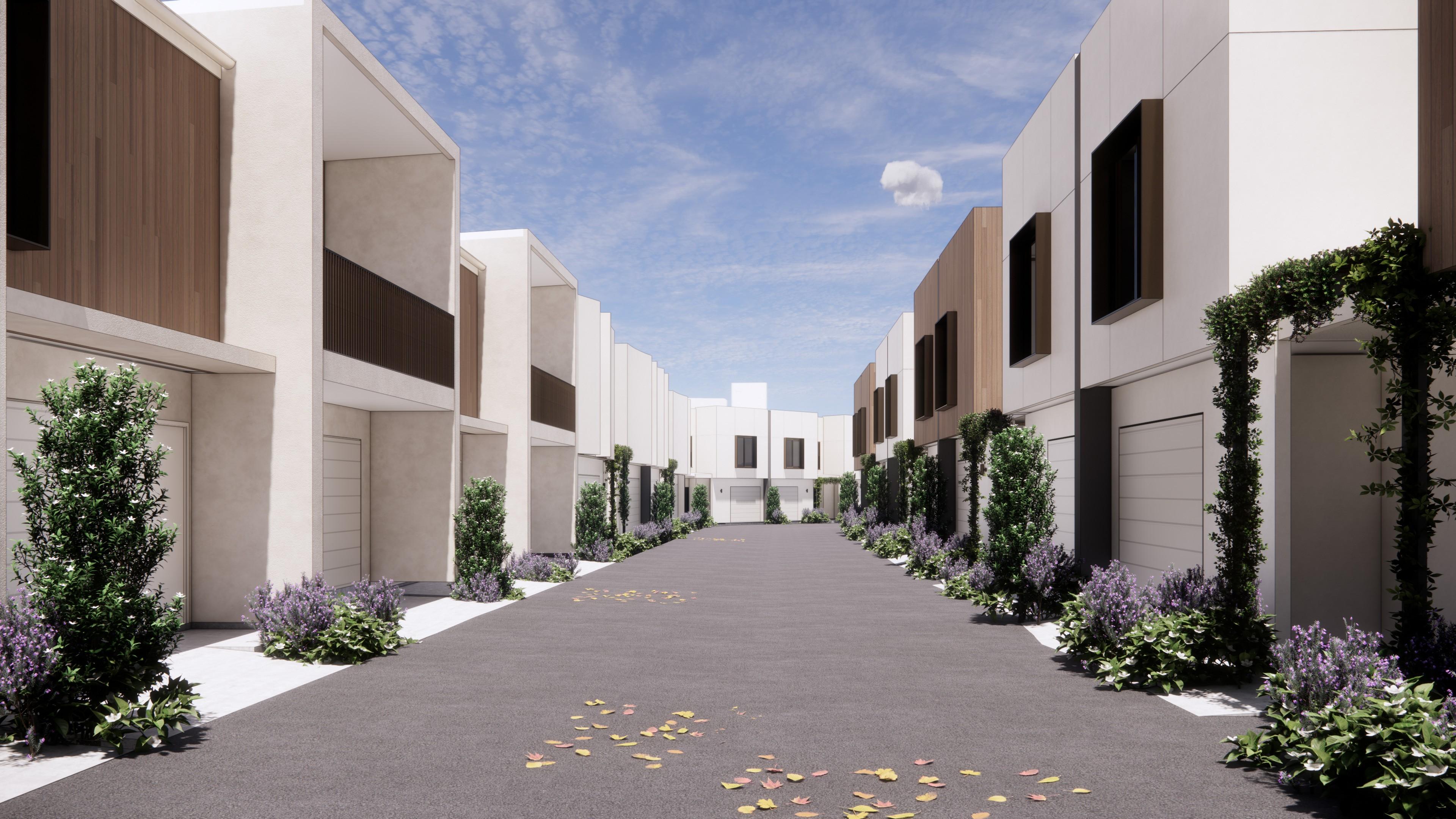 Central laneway between two rows of modern townhouses
