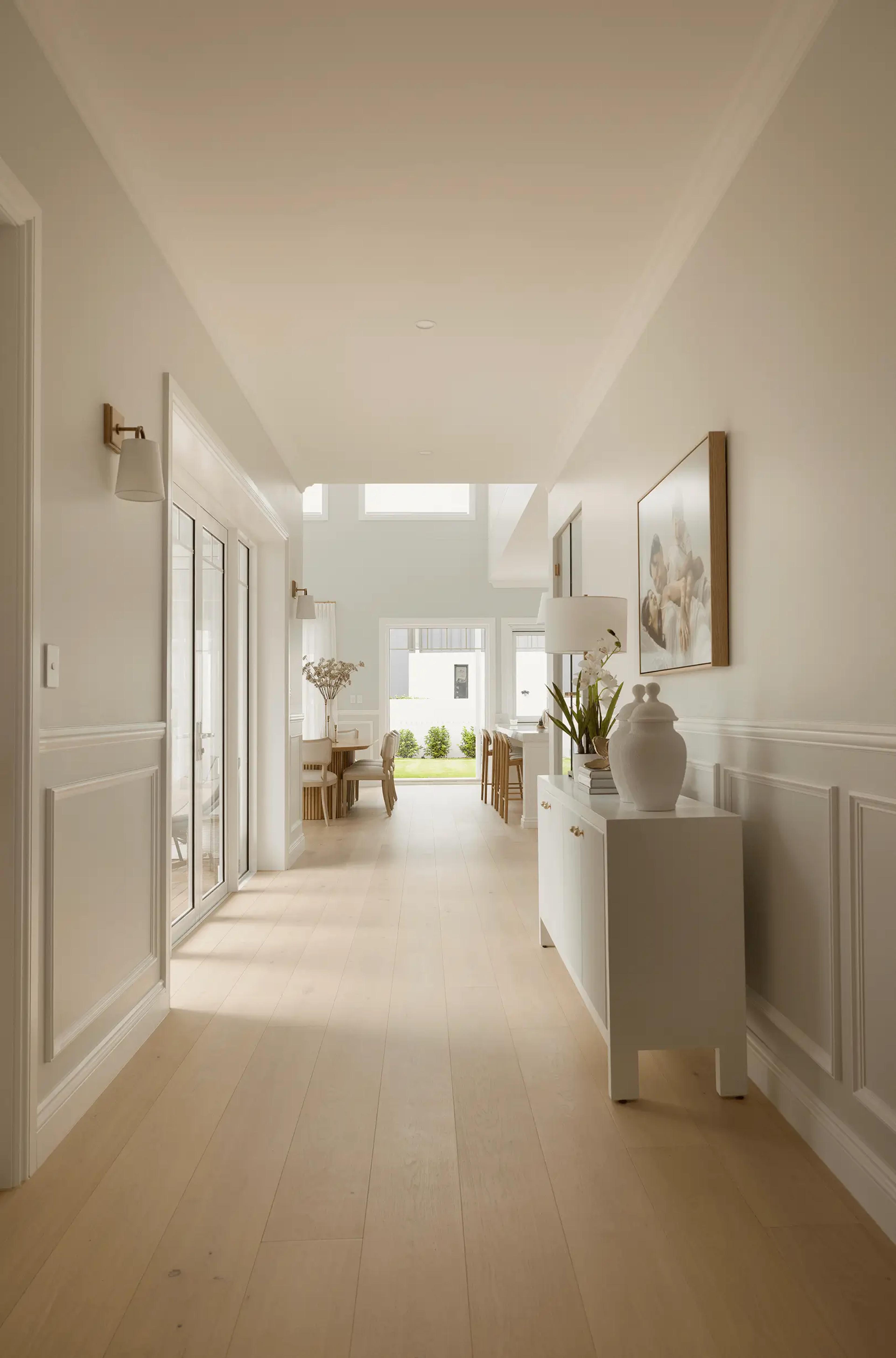 Long hallway leading to dining area and rear garden
