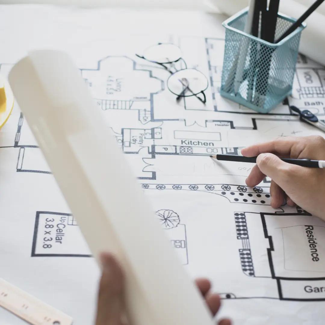 Architect reviewing house plans for Brisbane council approval and building certification.