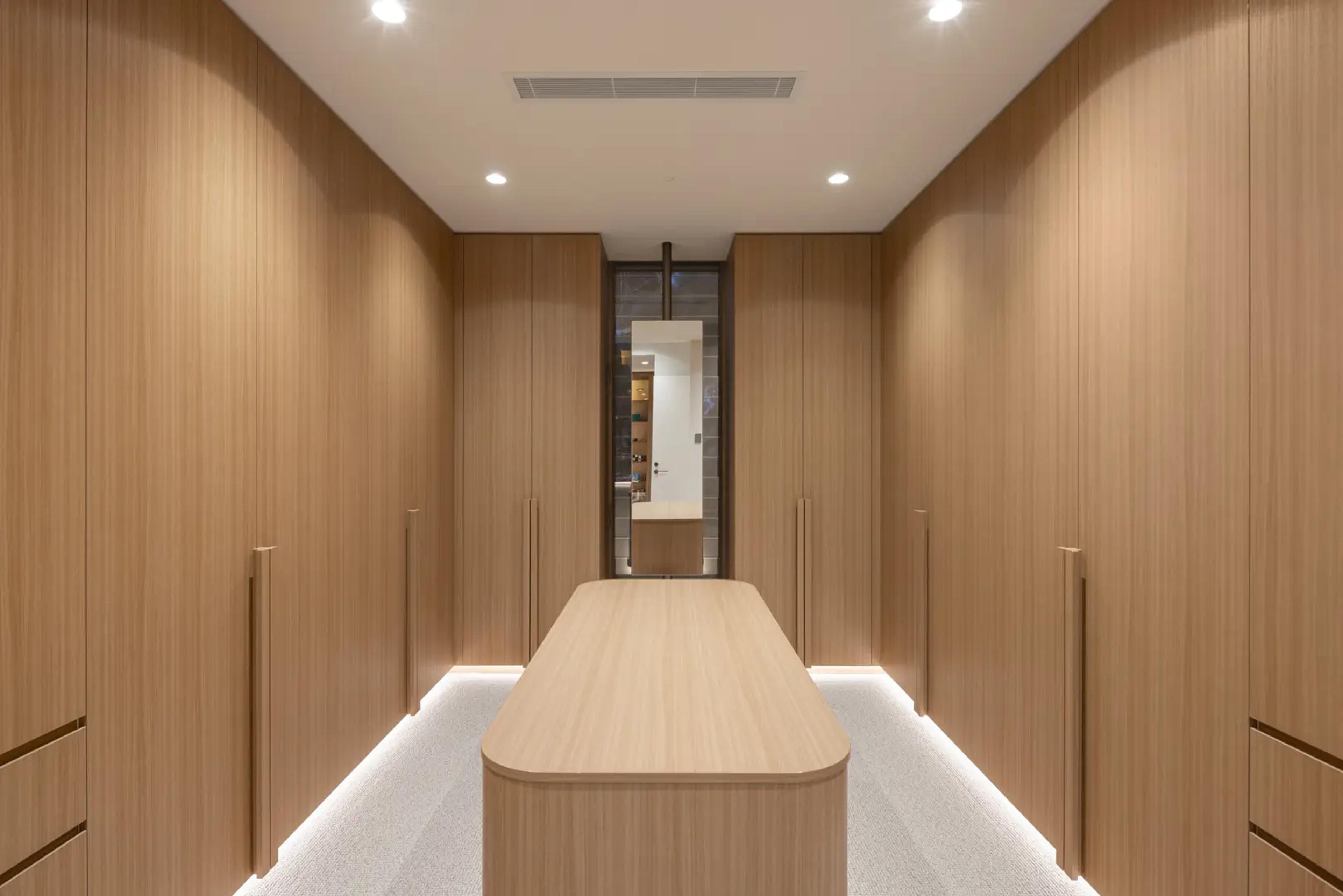 Dressing room with timber cabinetry and central island