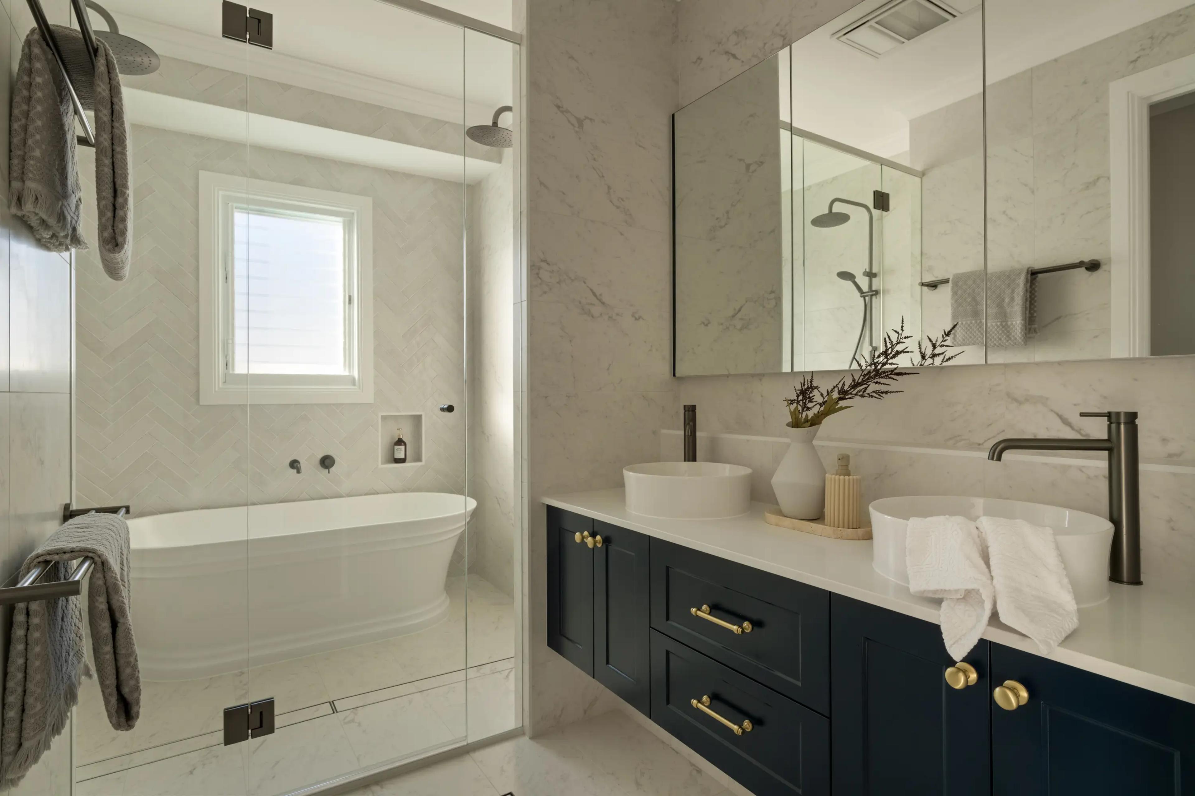 Ensuite with freestanding bath and navy double vanity