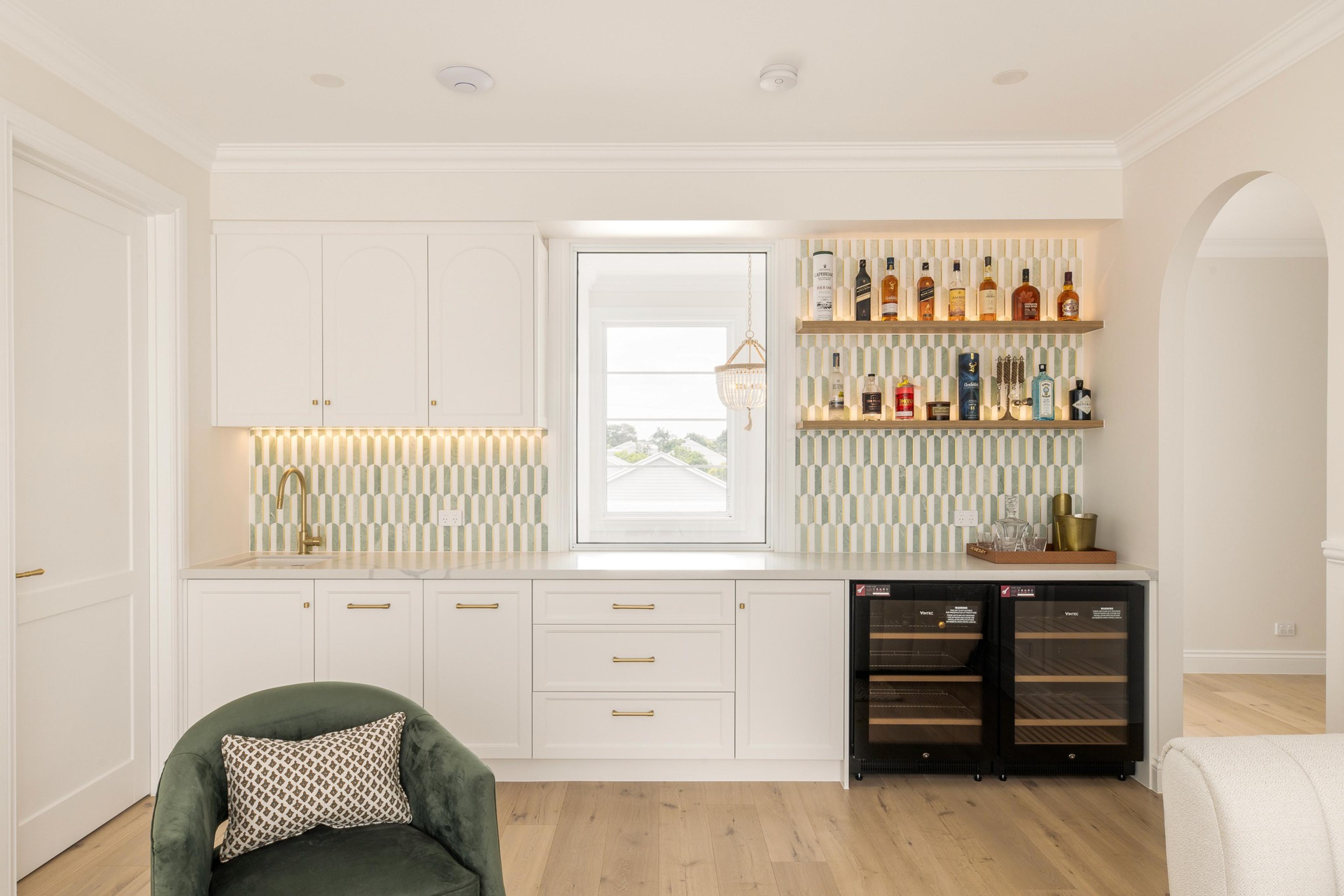 Butler's bar with white cabinetry, tiled splashback and wine fridges