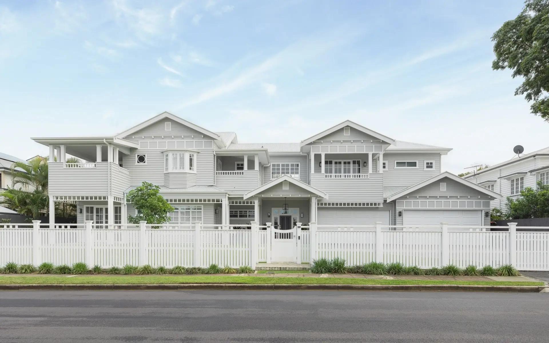 Australian Hamptons style facade with weatherboard cladding, gabled roofs and deep verandahs