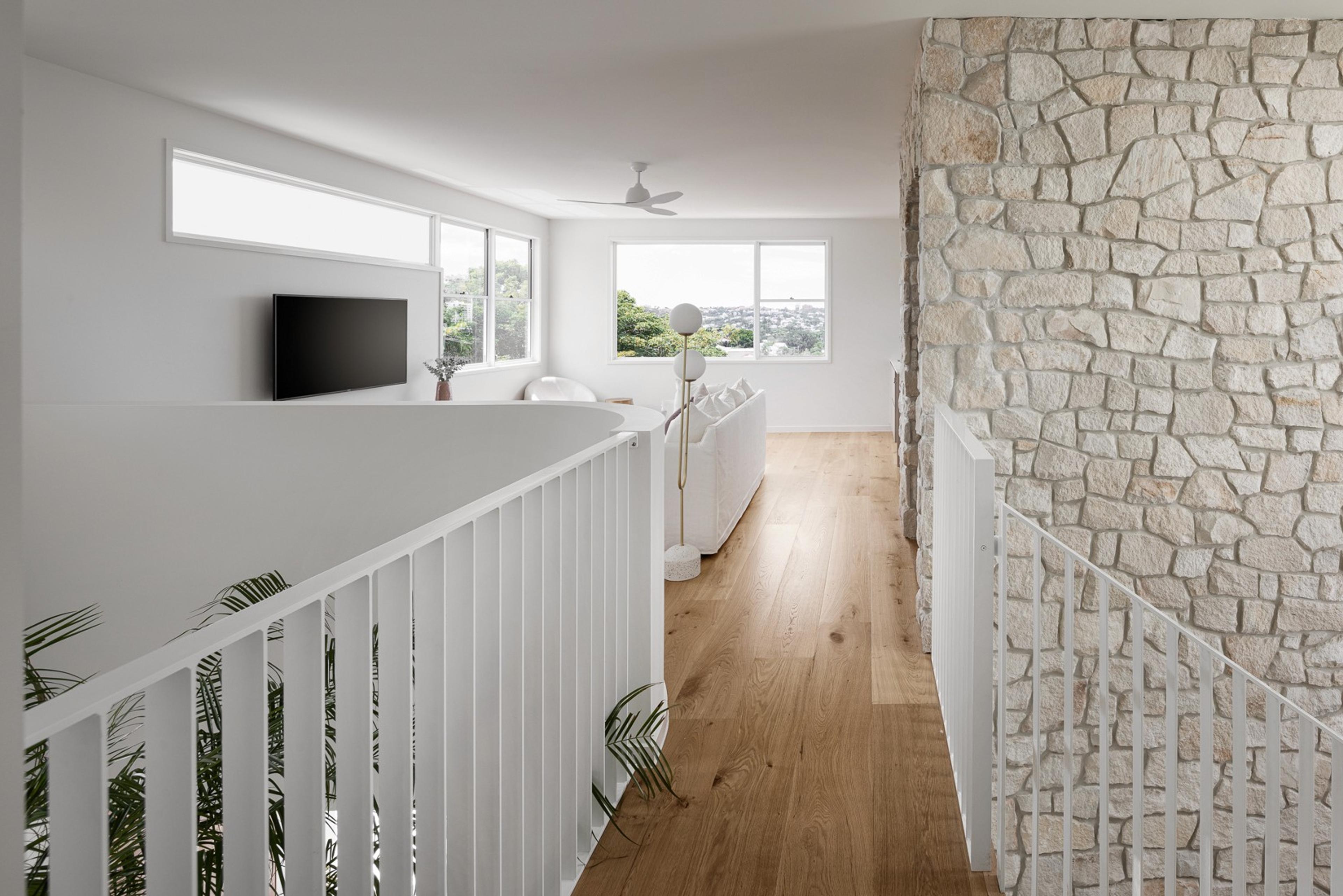 Upstairs landing with timber floors and stone feature wall