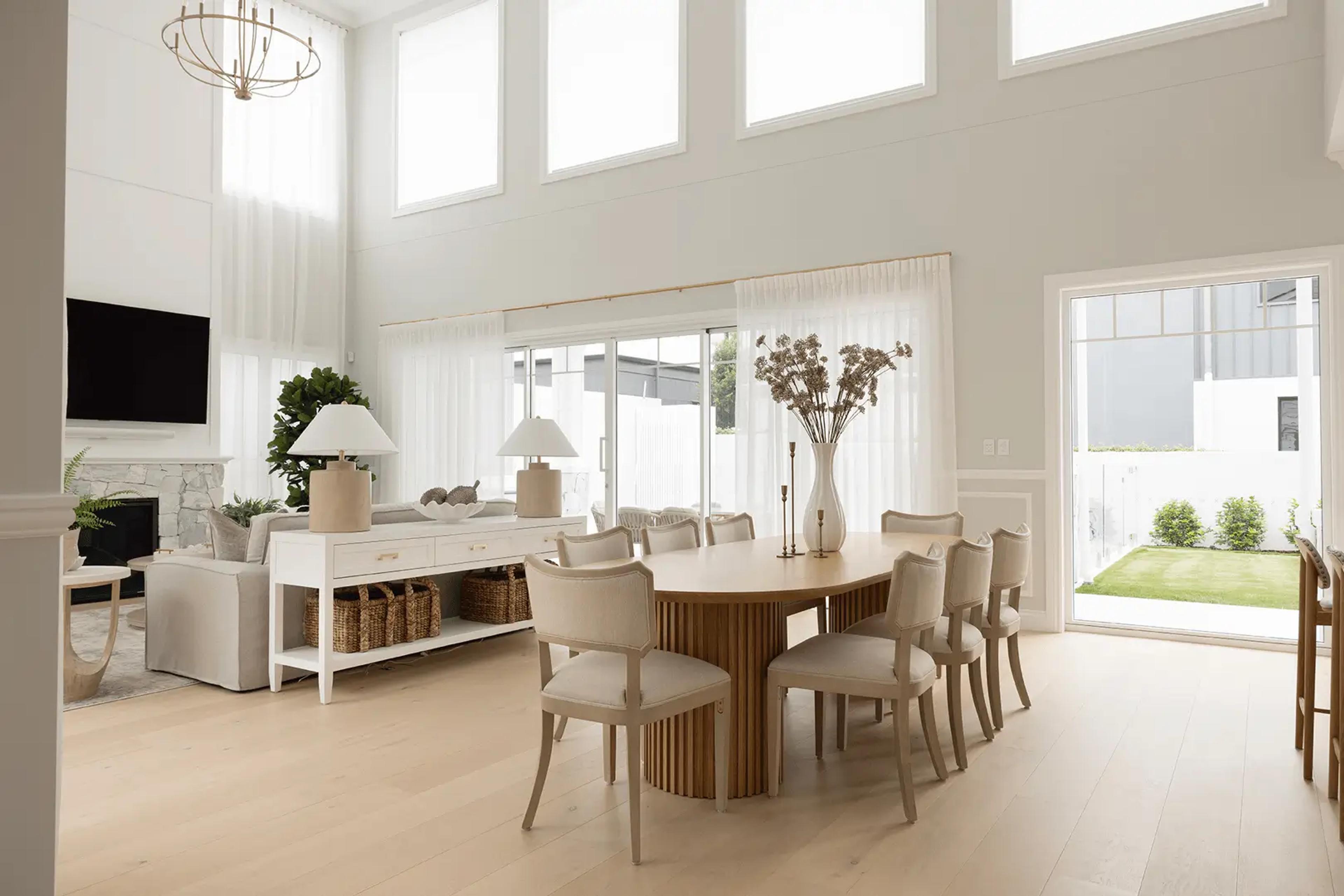Double-height dining room with oval timber table