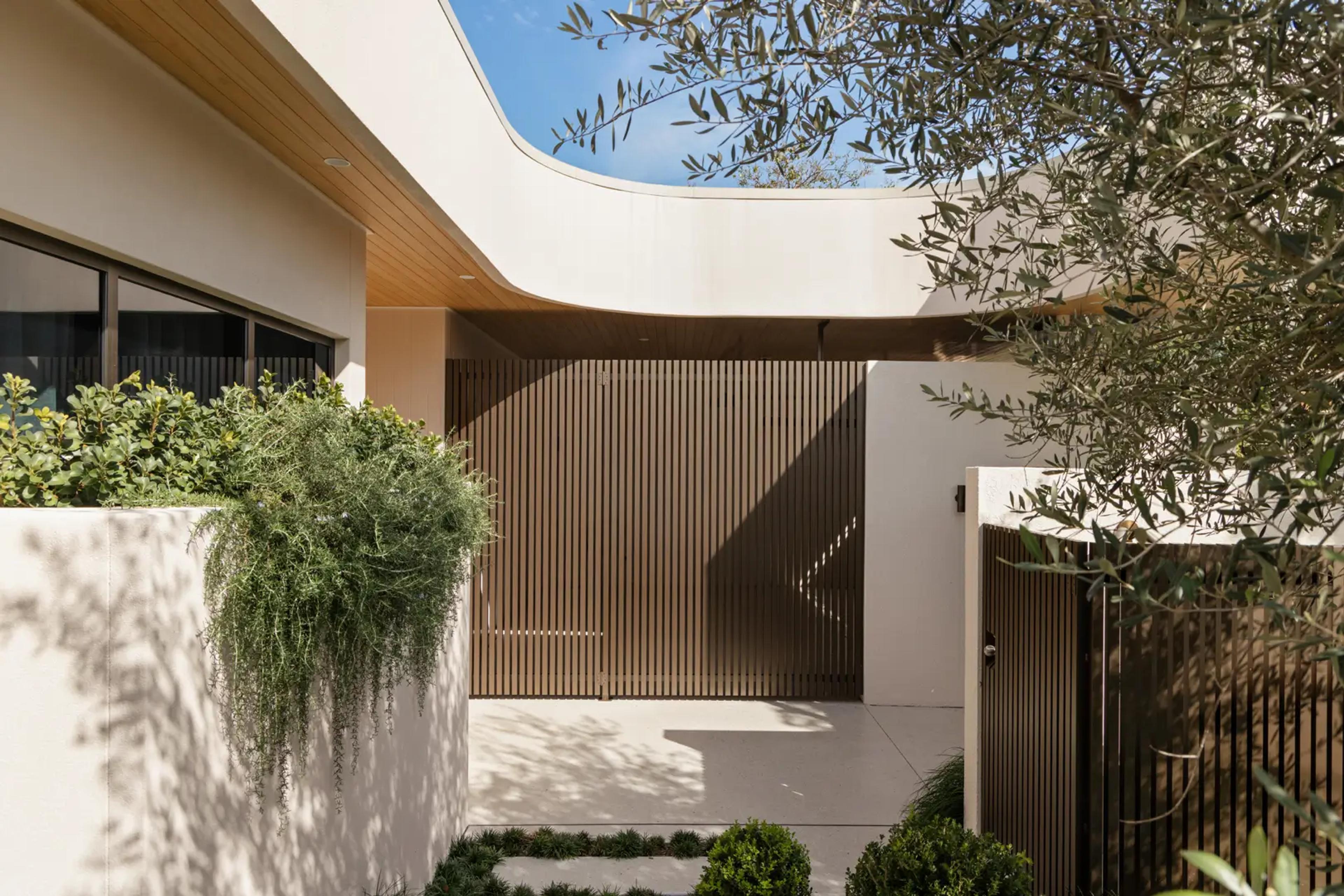 Front entry courtyard with timber screen and curved eave