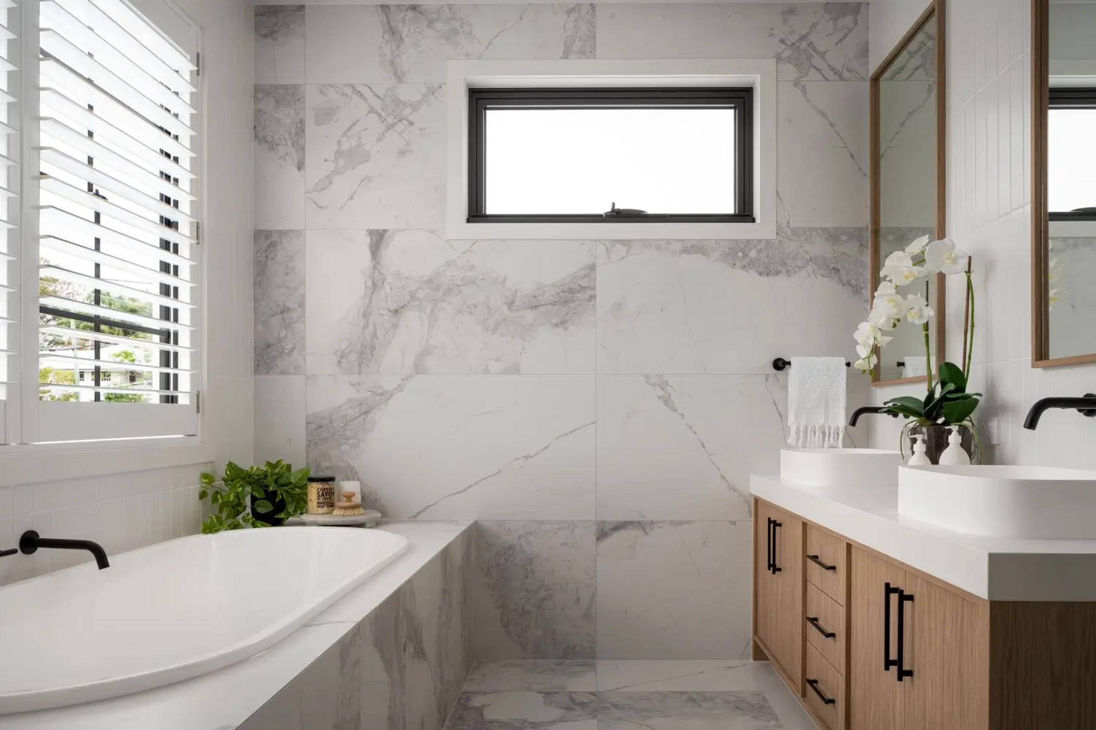 Marble bathroom with twin basins and freestanding tub