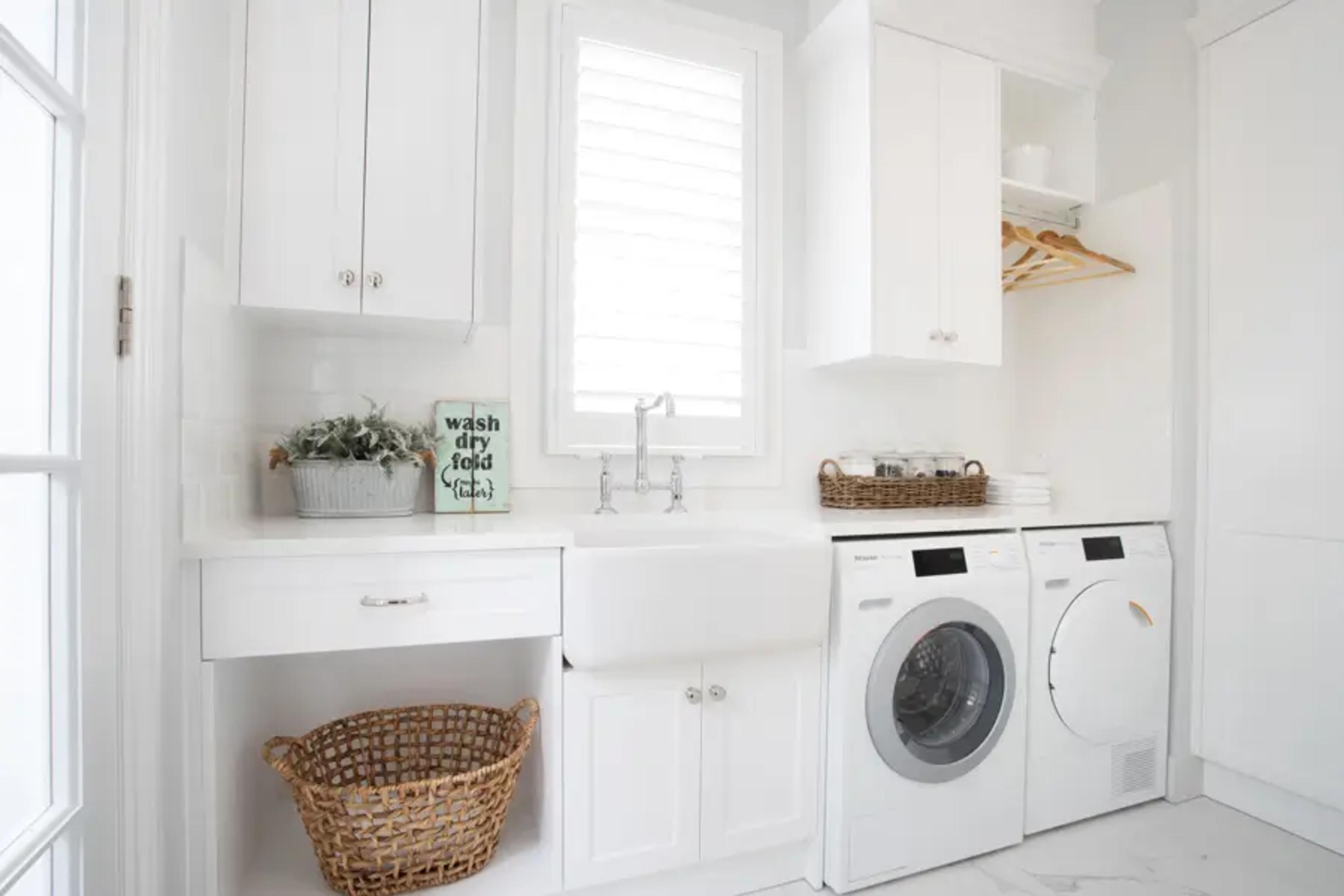 White laundry with farmhouse sink and appliances