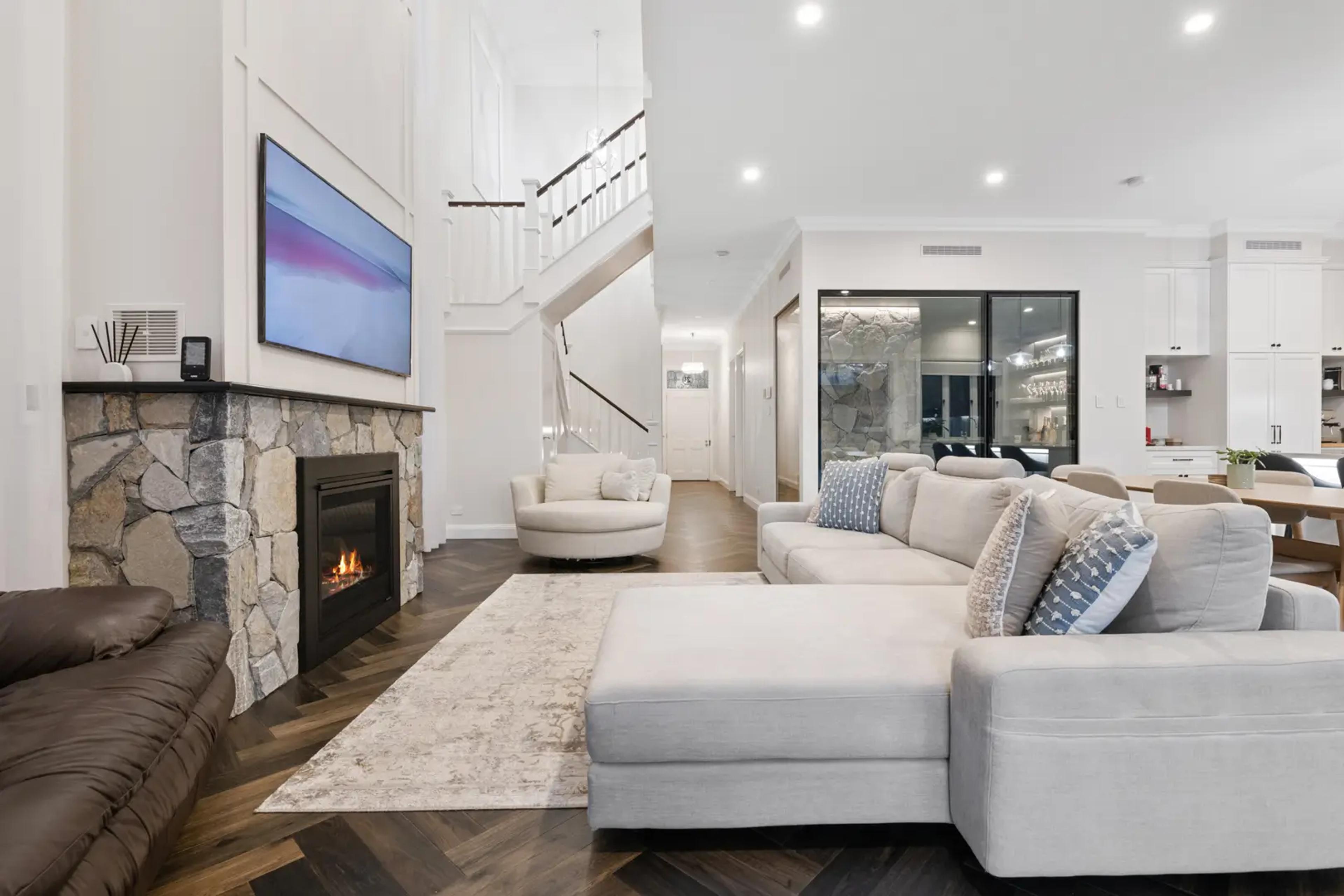 Living room with stone fireplace and cream sofa