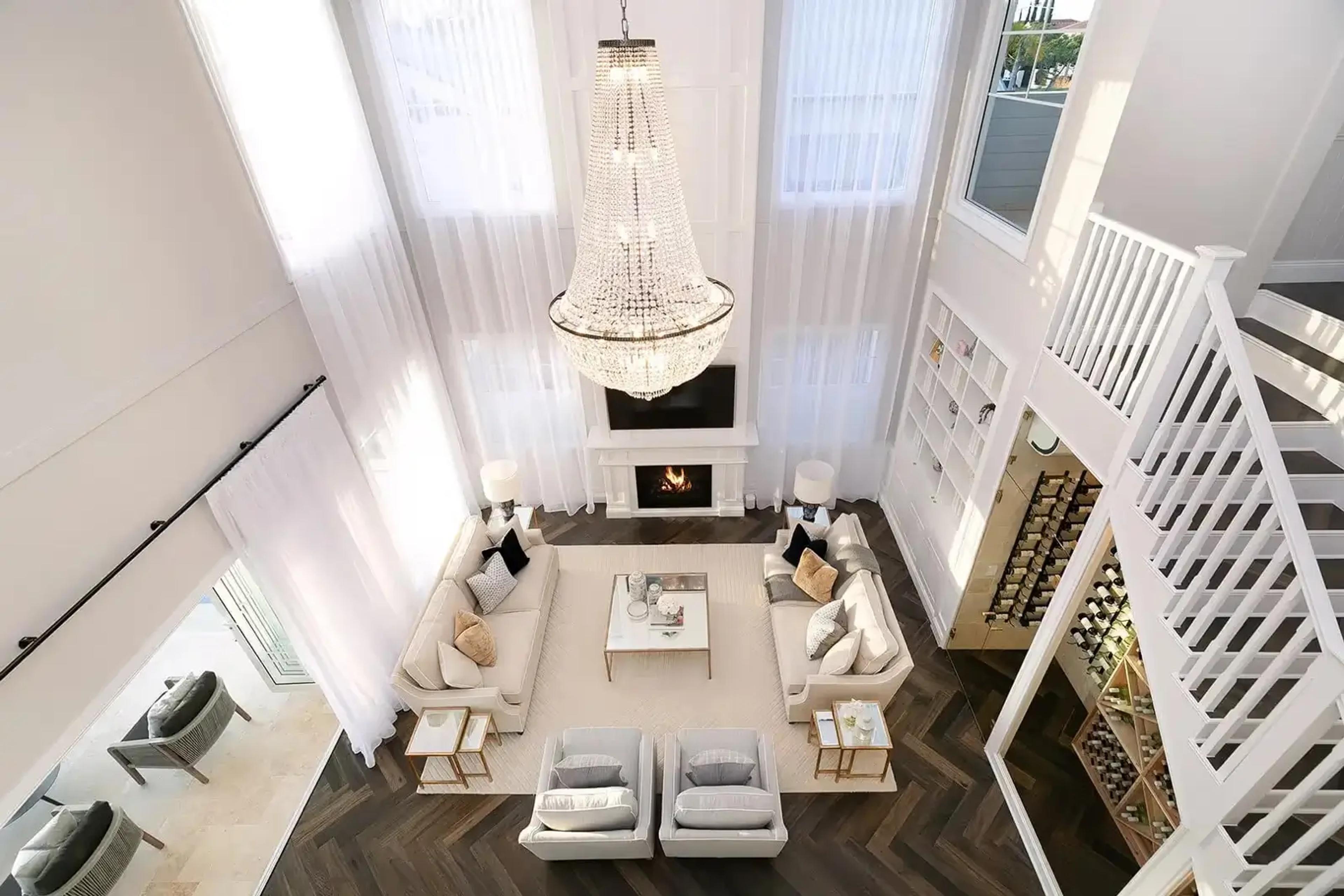 Overhead view of lounge with chandelier, fireplace and wine cellar