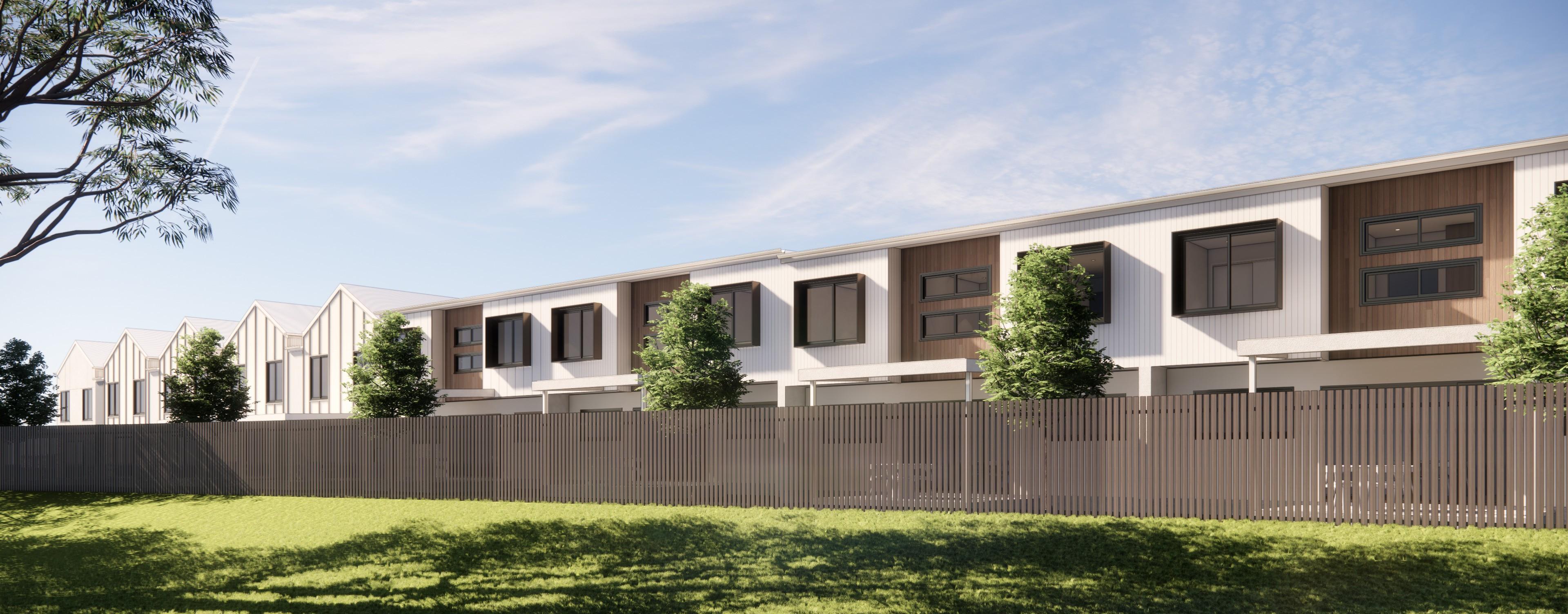 Rear view of townhouse development behind timber fence