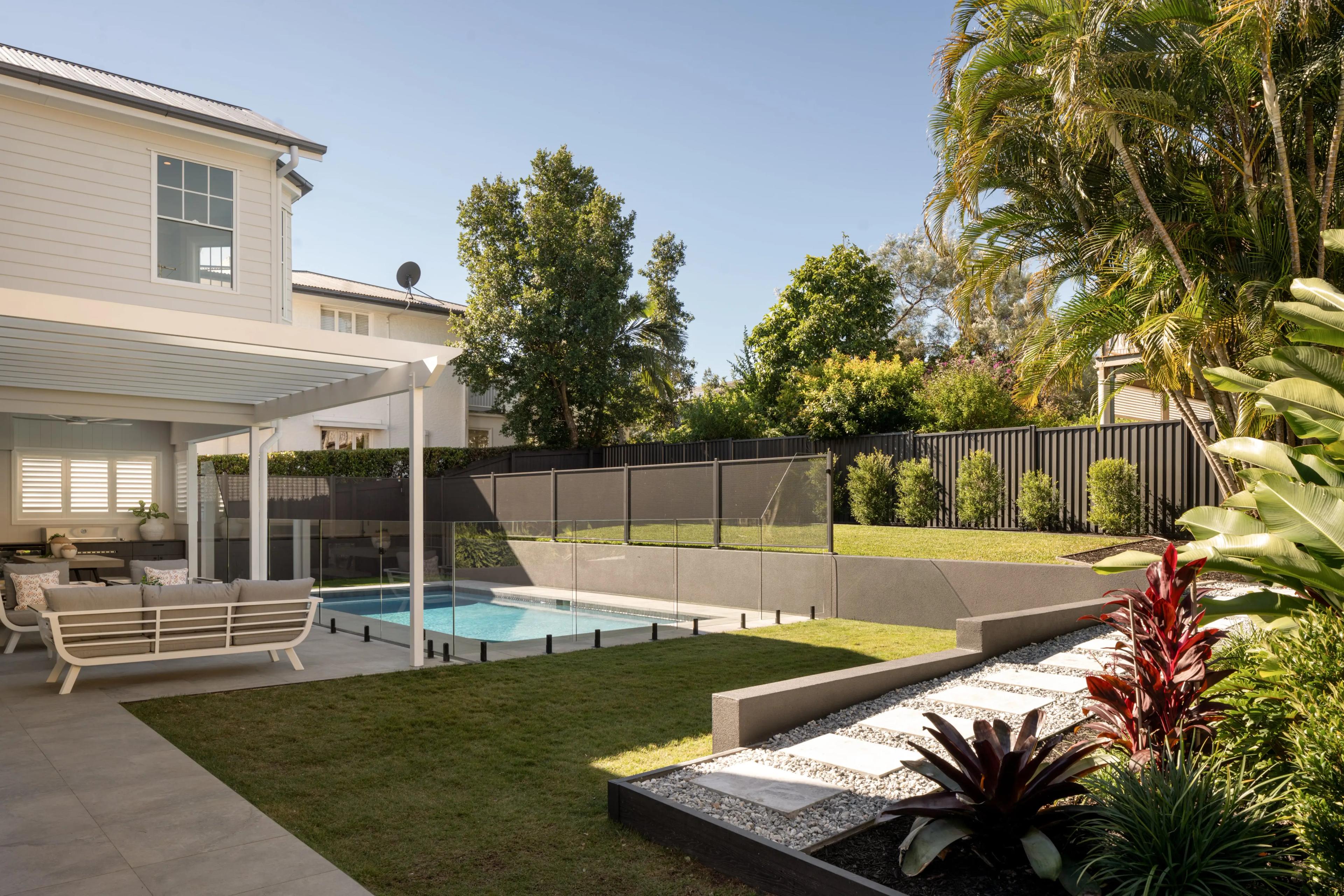 Backyard with pool, glass fencing and covered patio