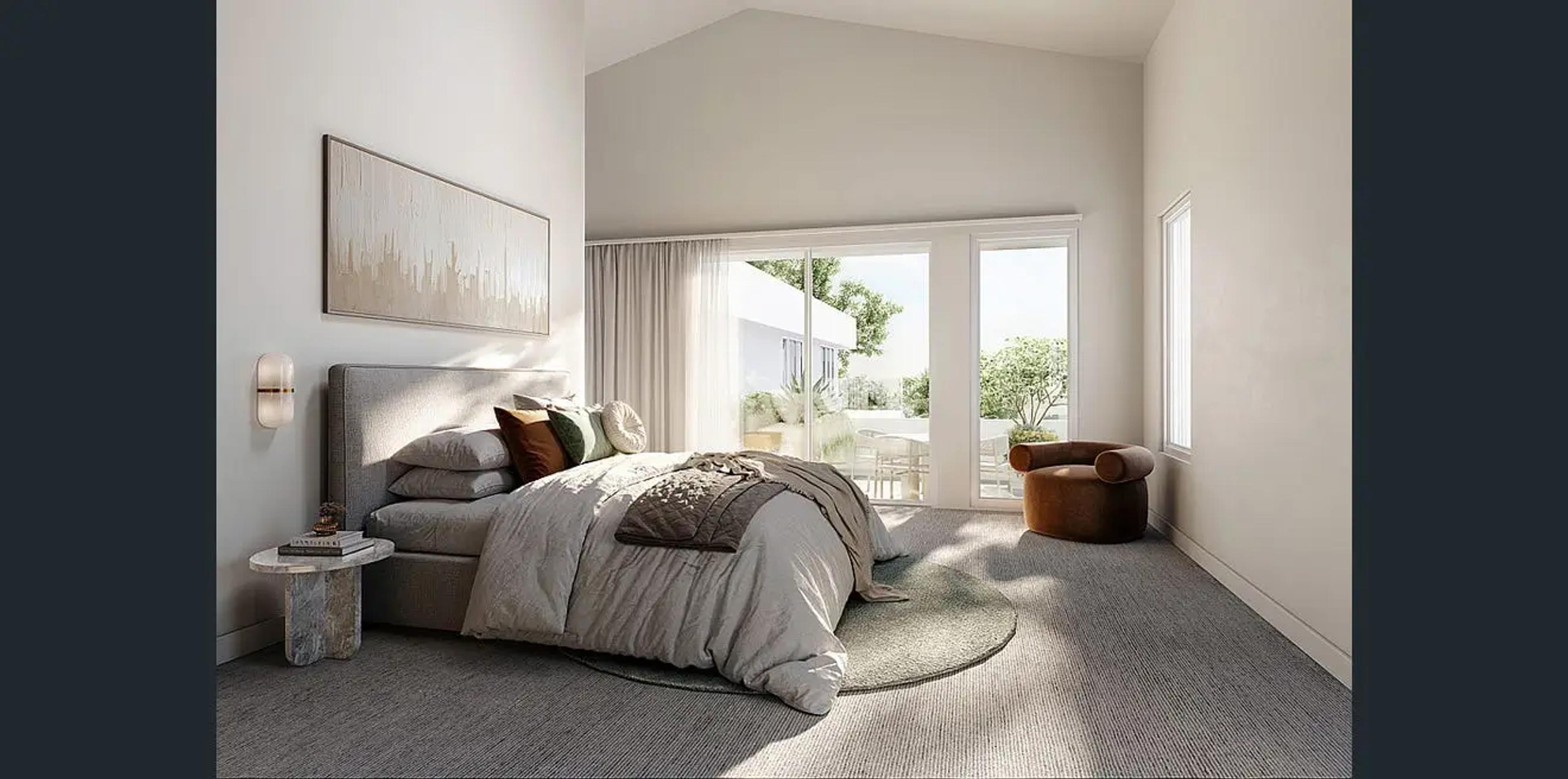 Main bedroom with upholstered bed and sliding doors to balcony