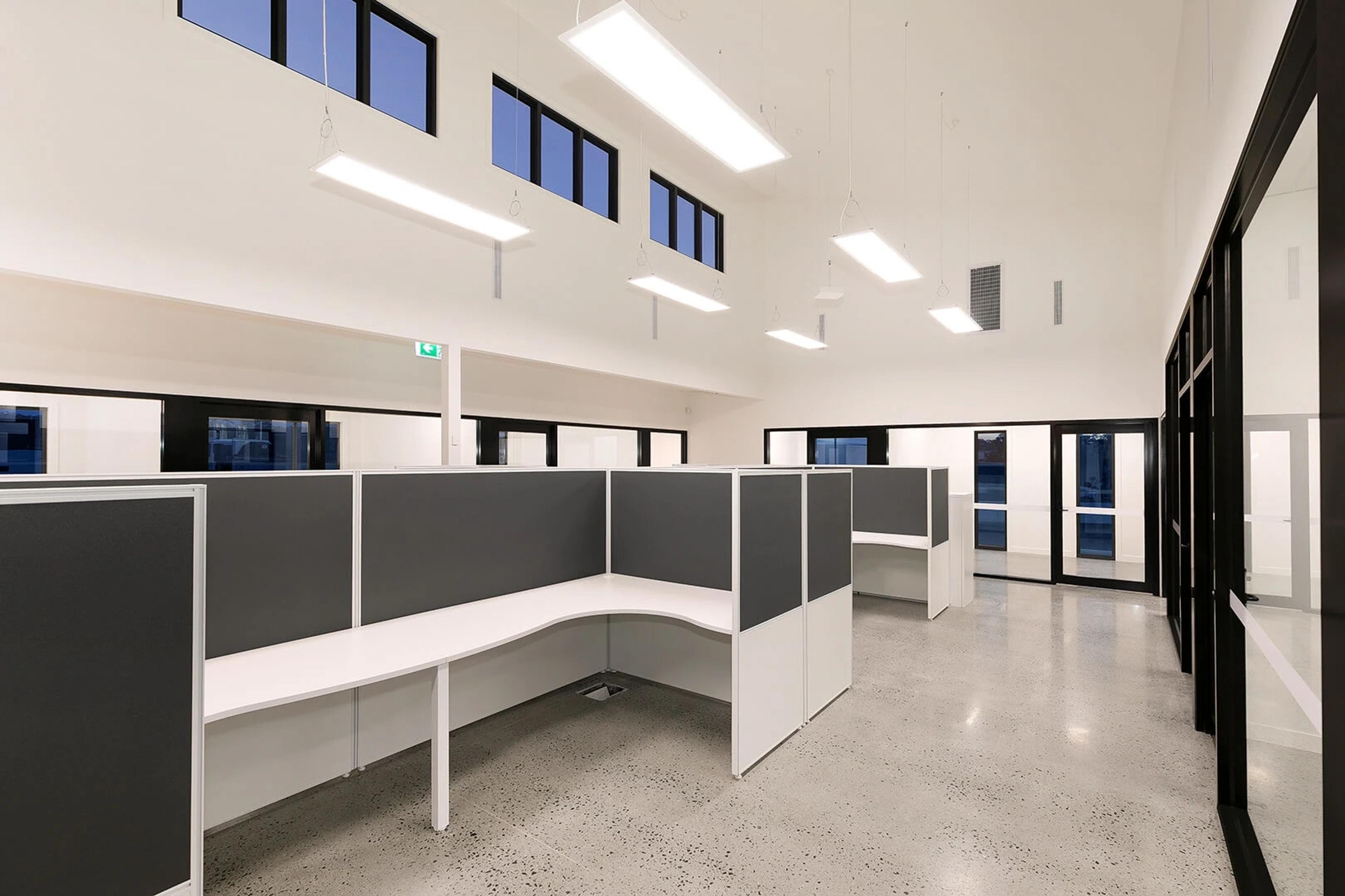 Cubicle desks below clerestory windows in open office