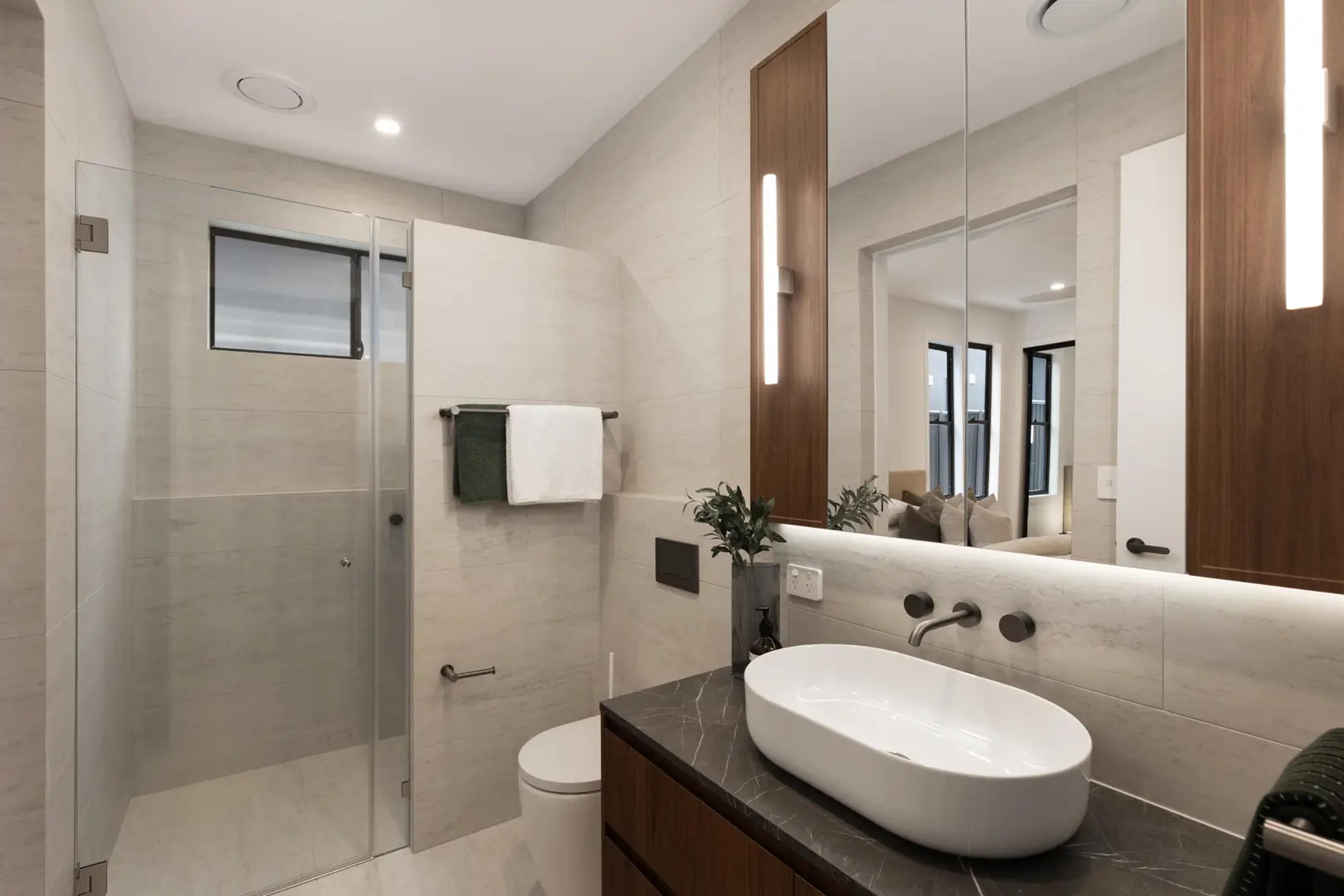 Bathroom with glass shower and stone vanity