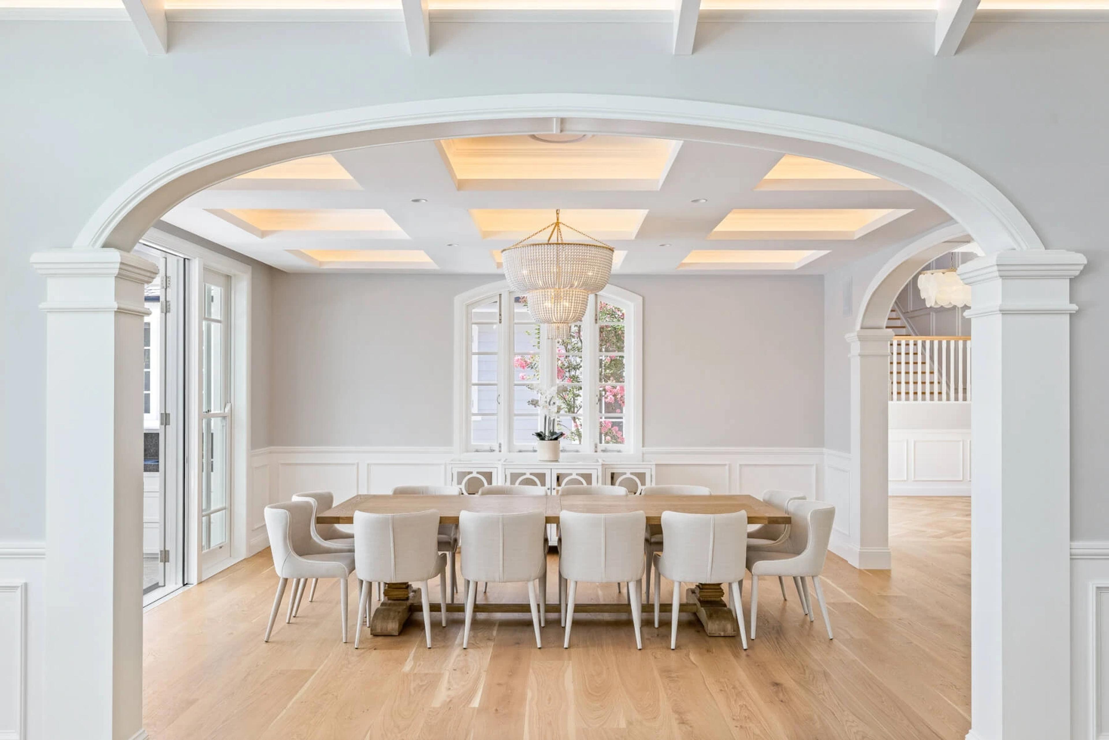 Formal dining room with long timber table and coffered ceiling
