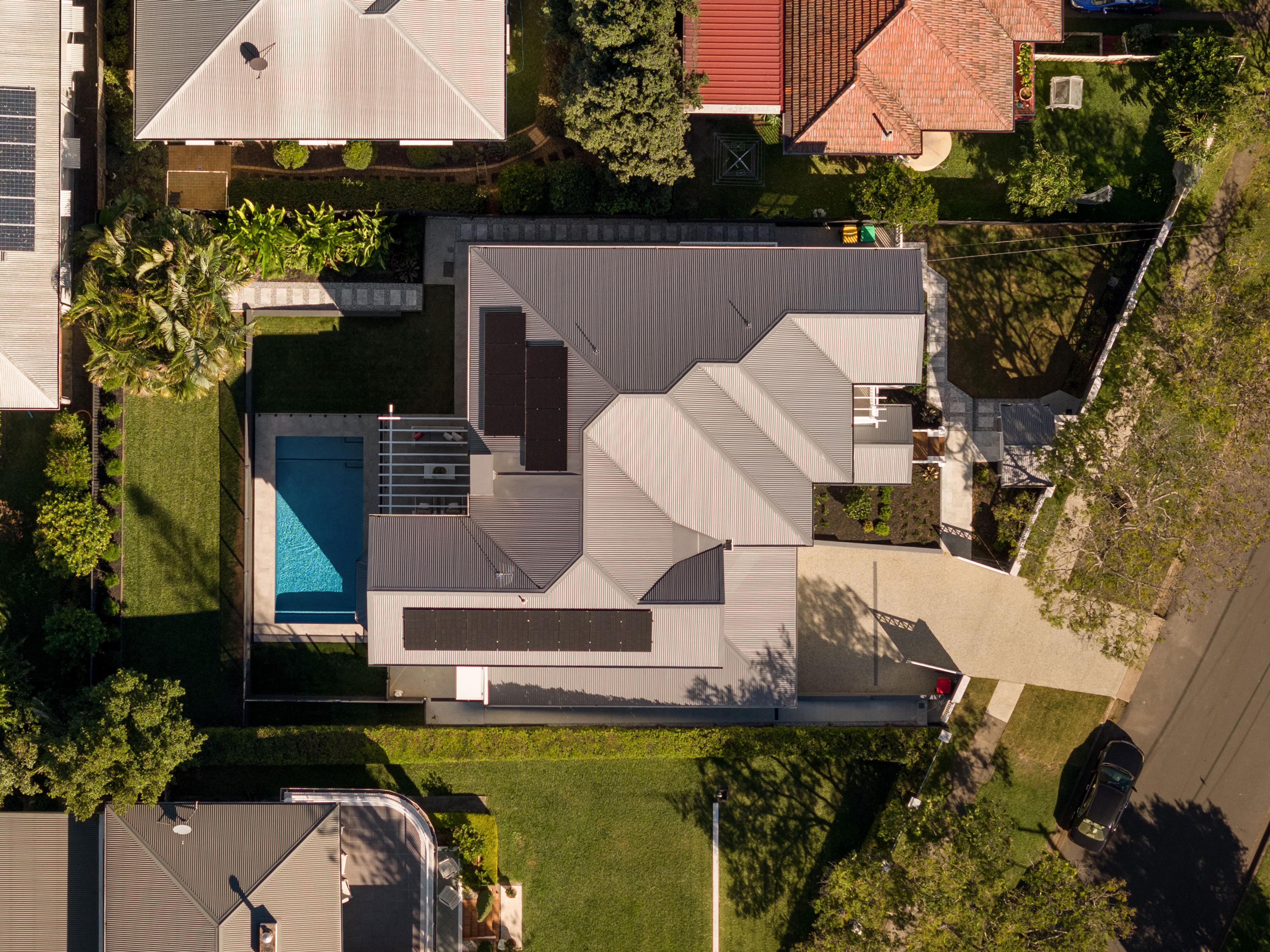 Aerial view of the home, pool and neighbouring rooftops