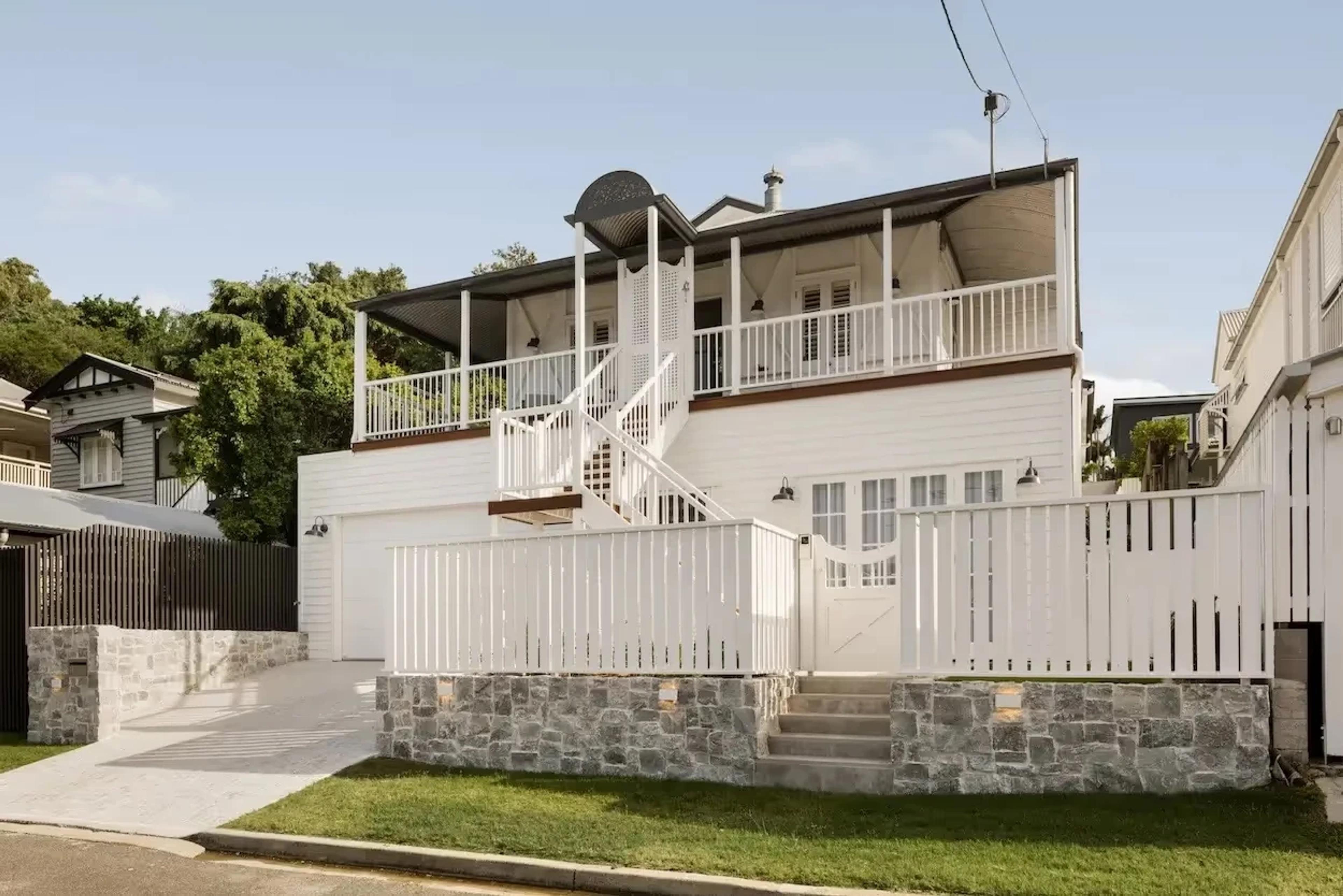 odern Queenslander house design featuring a traditional elevated structure and shaded verandah