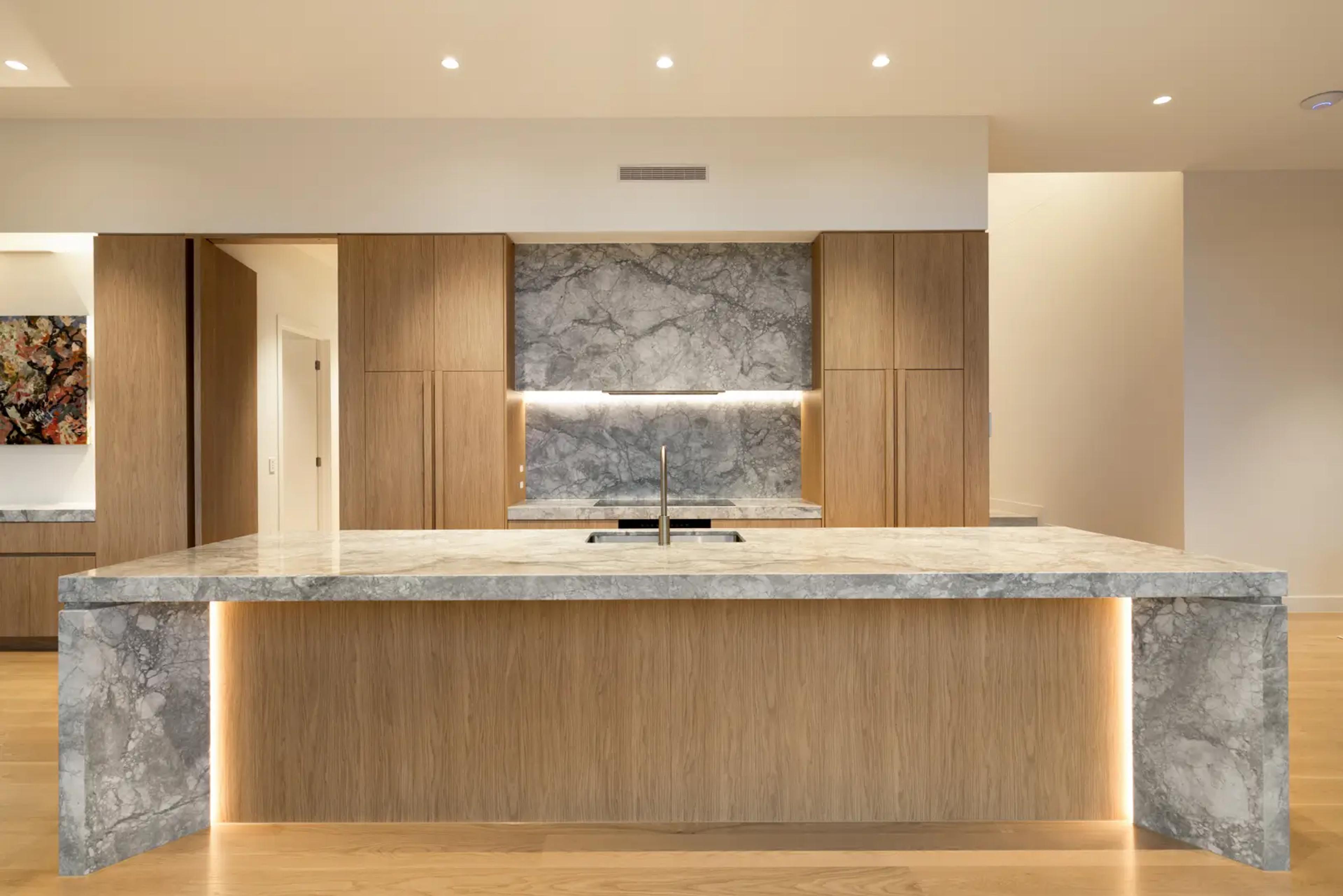 Kitchen with marble island bench and timber joinery