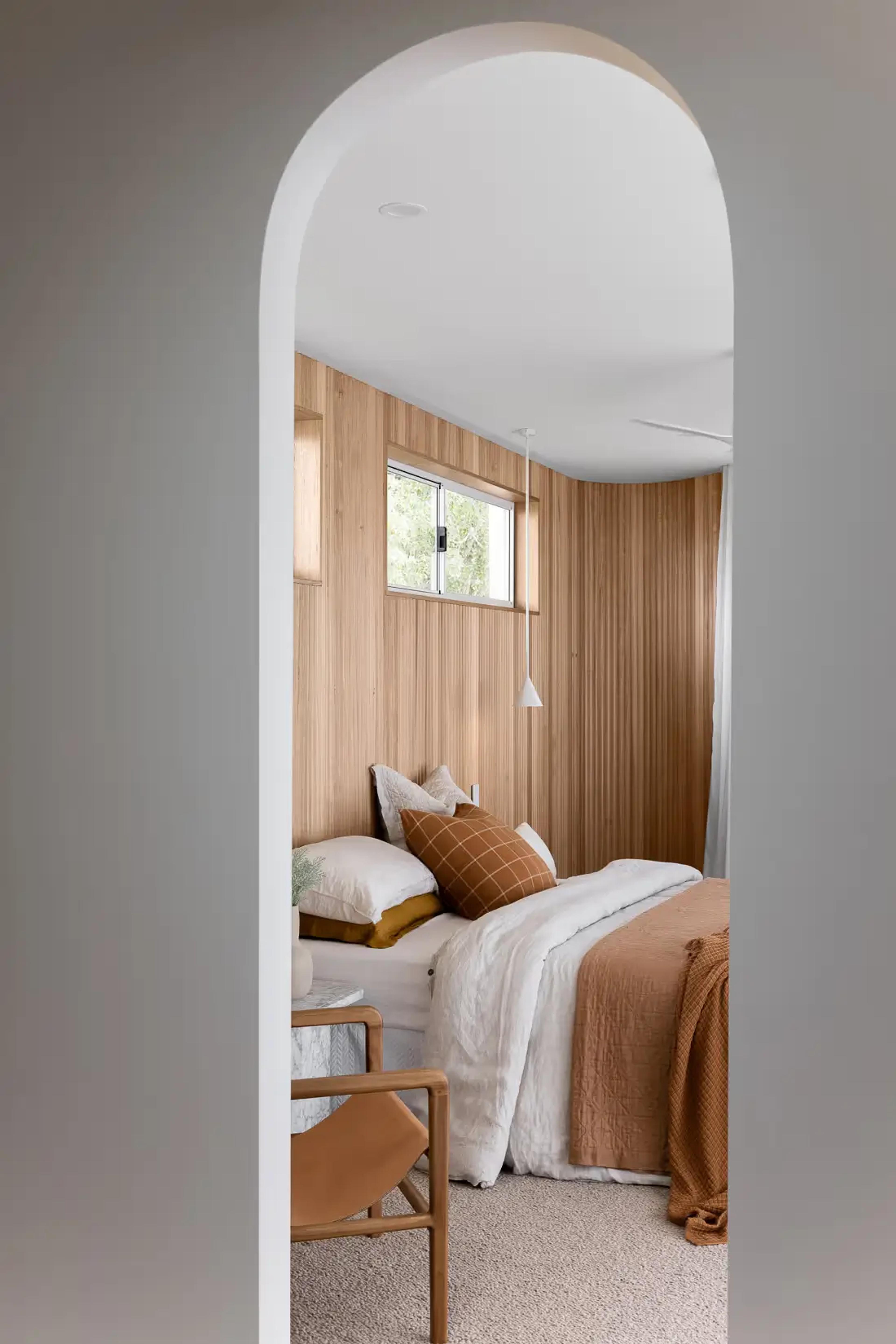 Custom arched doorway framing a luxury bedroom interior design