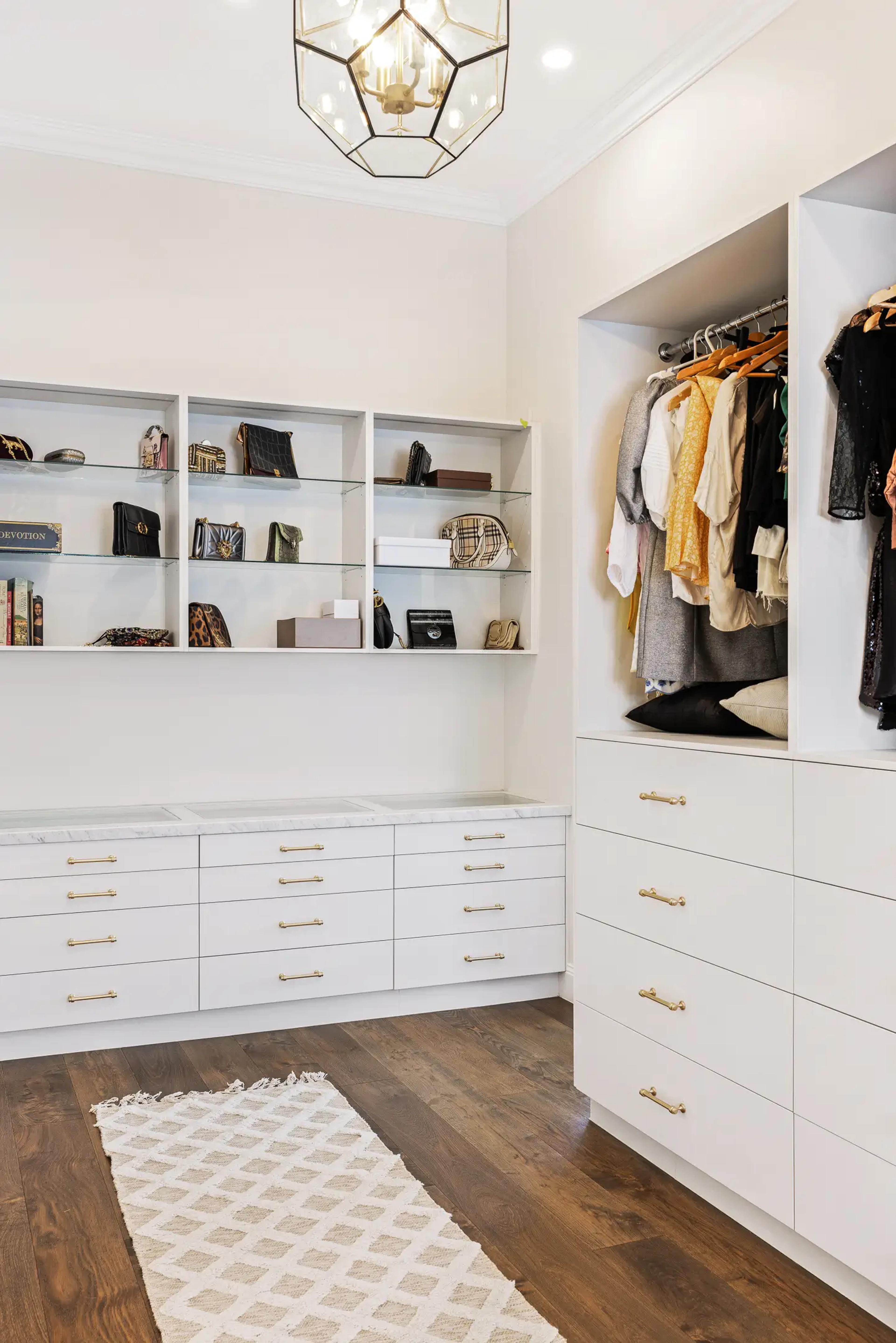 Dressing room with white joinery and glass display shelves