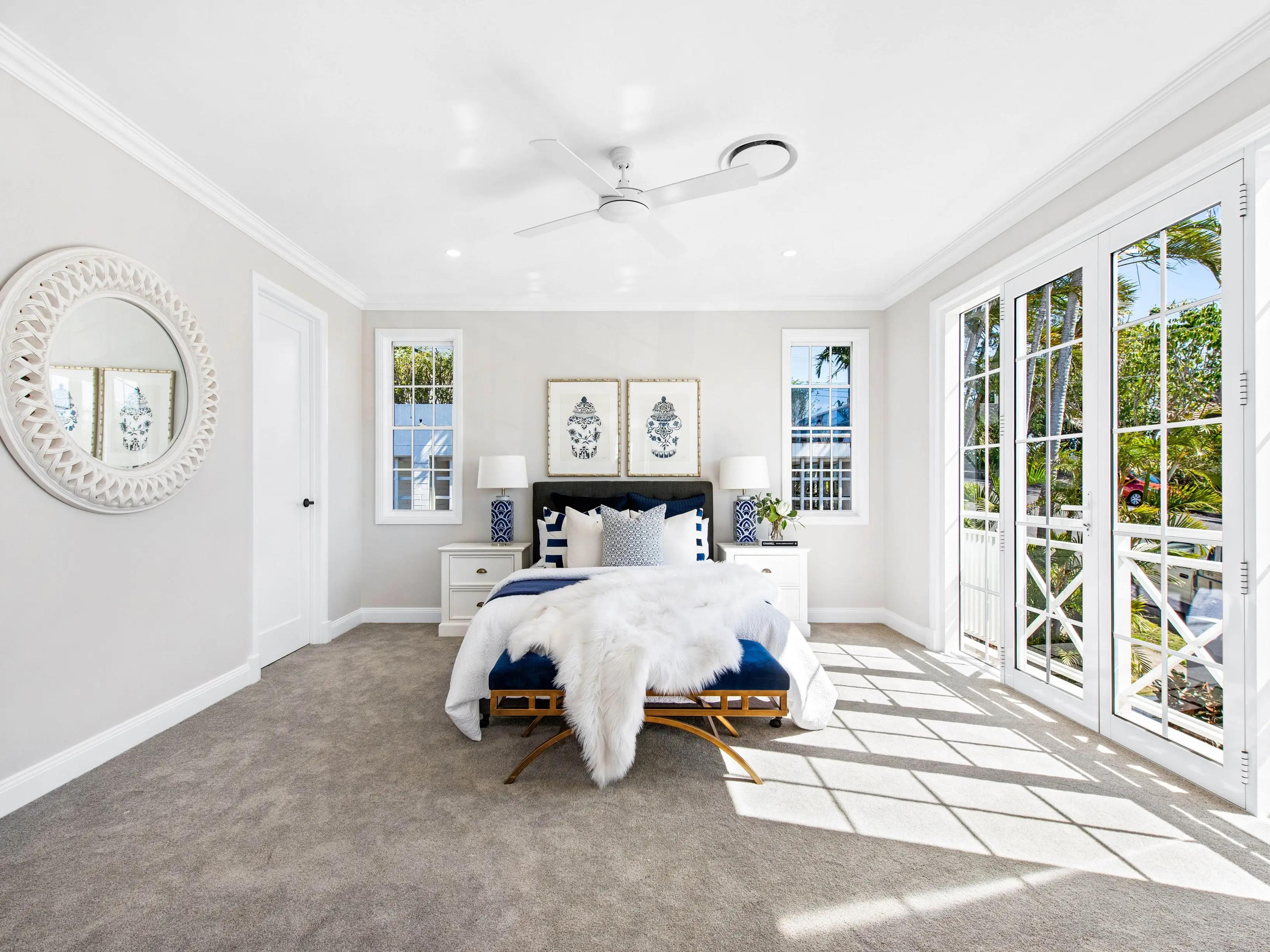 Bedroom with French doors opening to a balcony