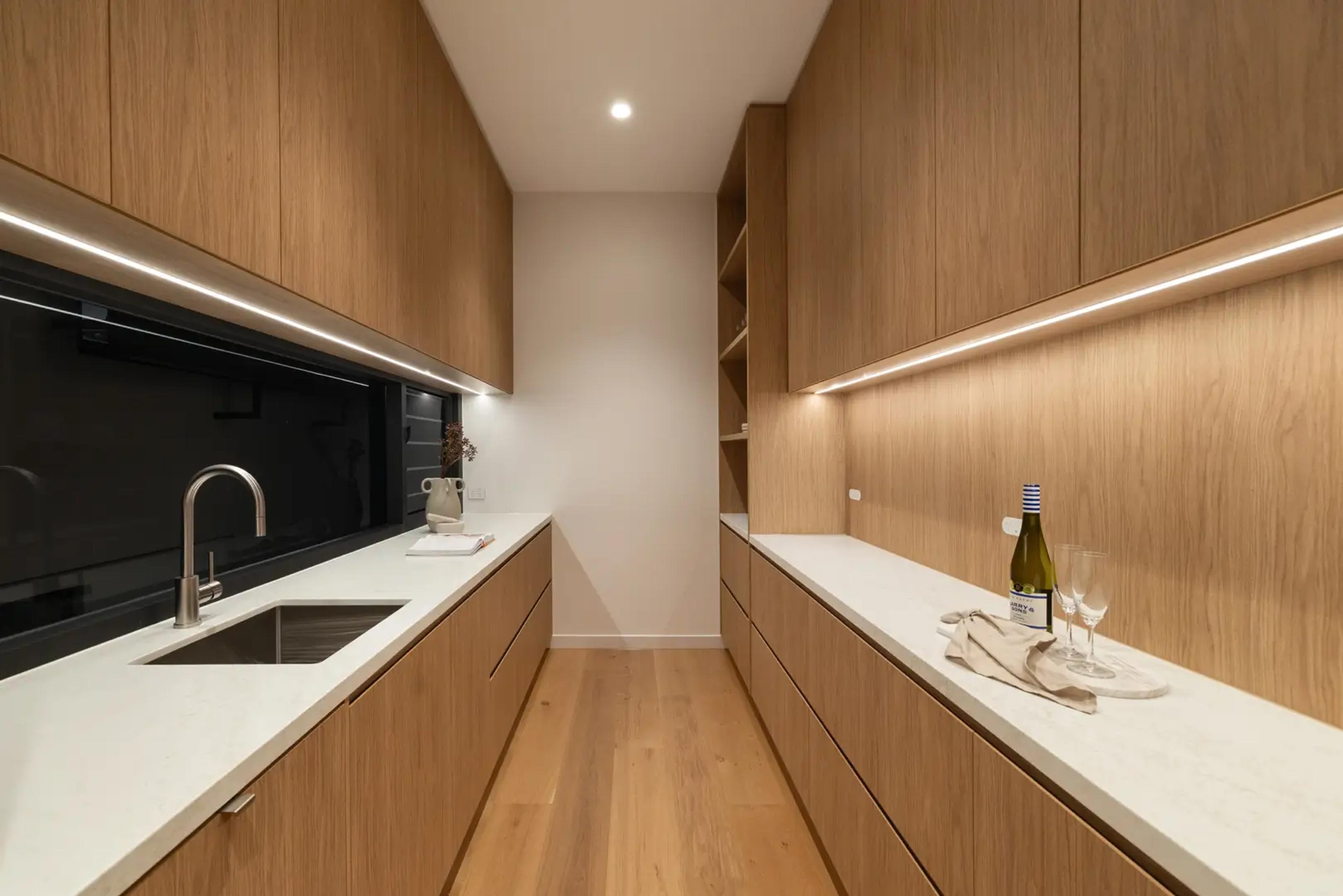 Butler's pantry with timber joinery and stone benchtops
