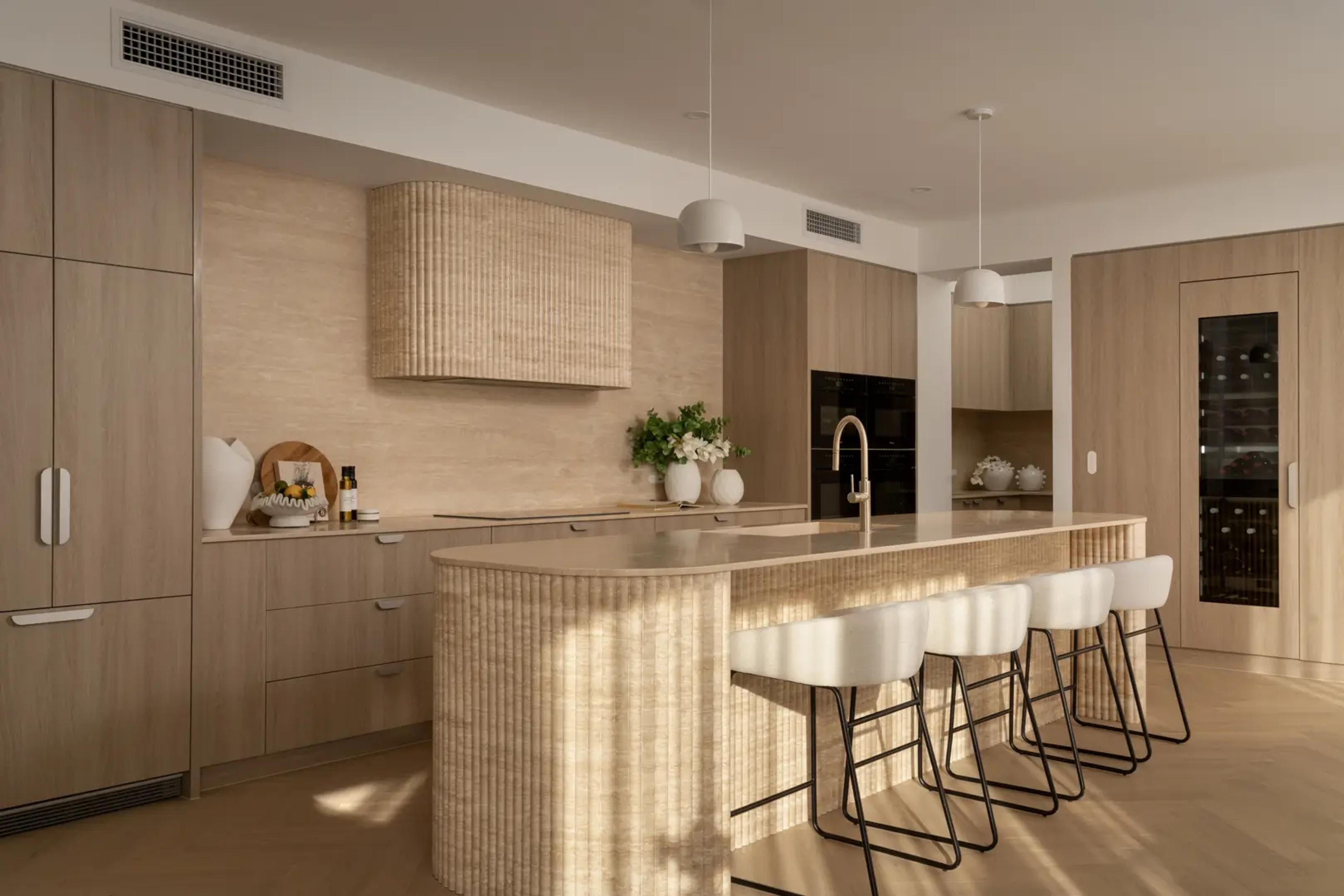 Kitchen with fluted timber island and pale oak cabinetry