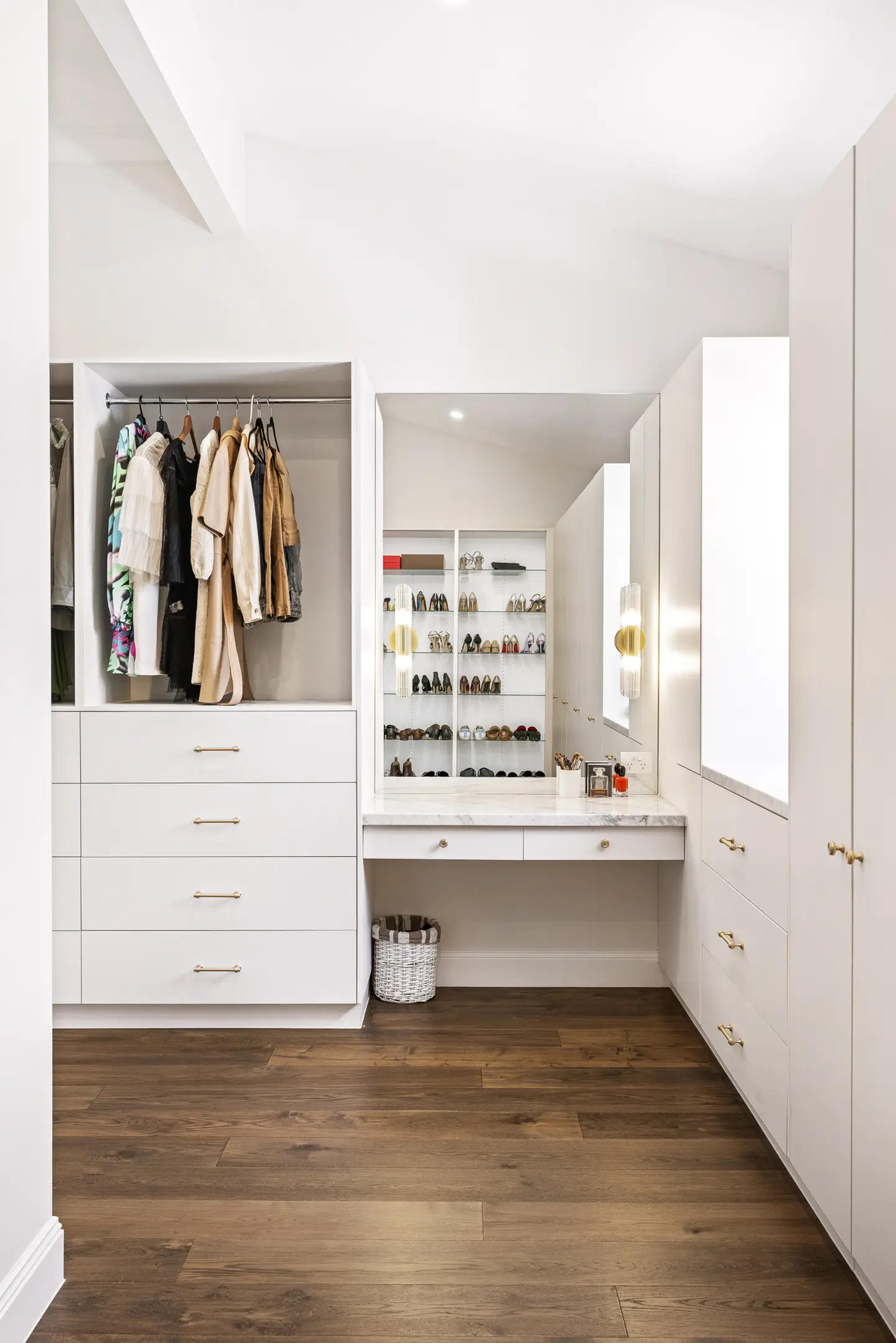 Walk in wardrobe with hanging space and shoe shelves