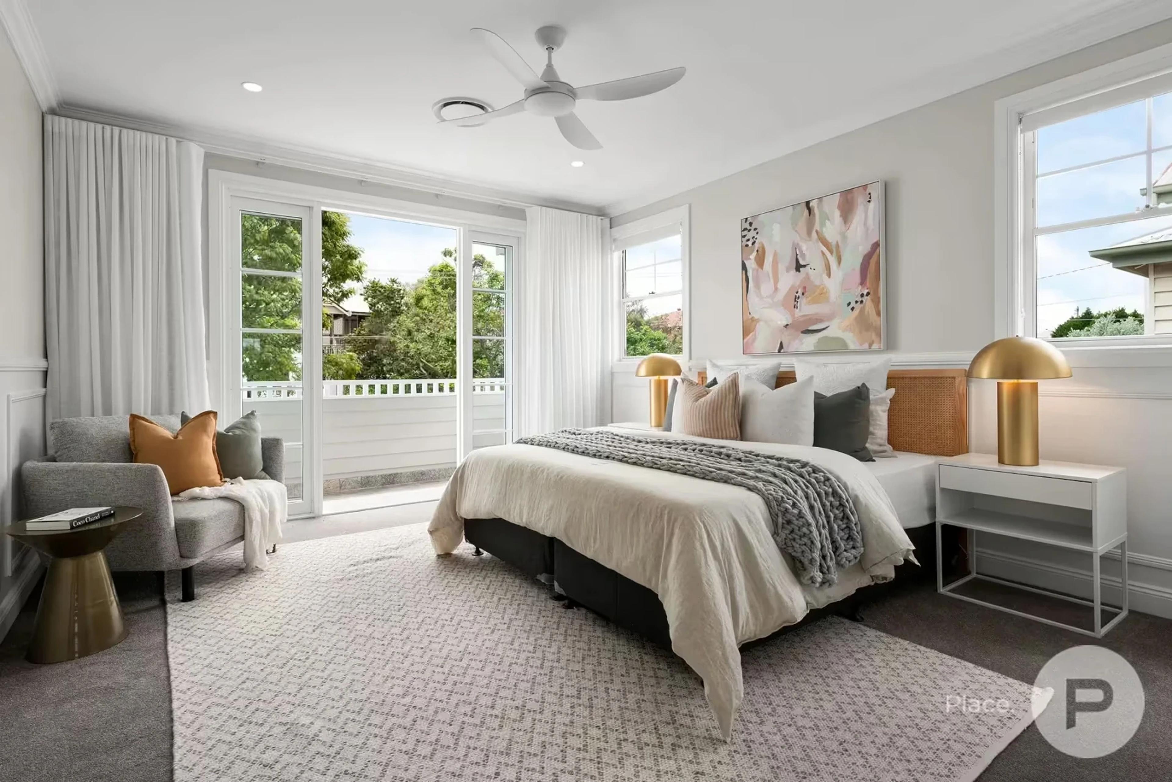 Bedroom with balcony doors and ceiling fan