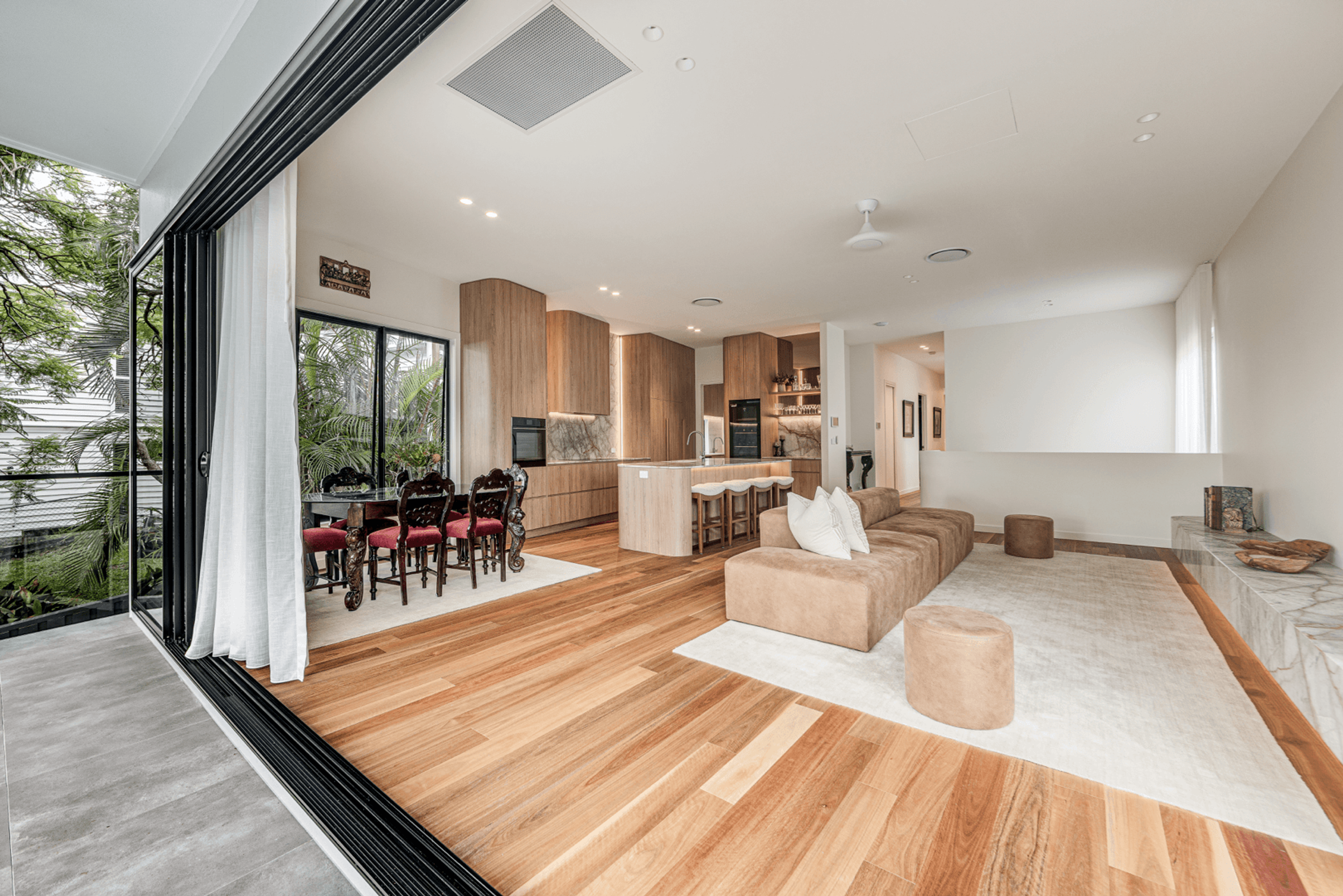 Open living and kitchen space with sliding doors to garden