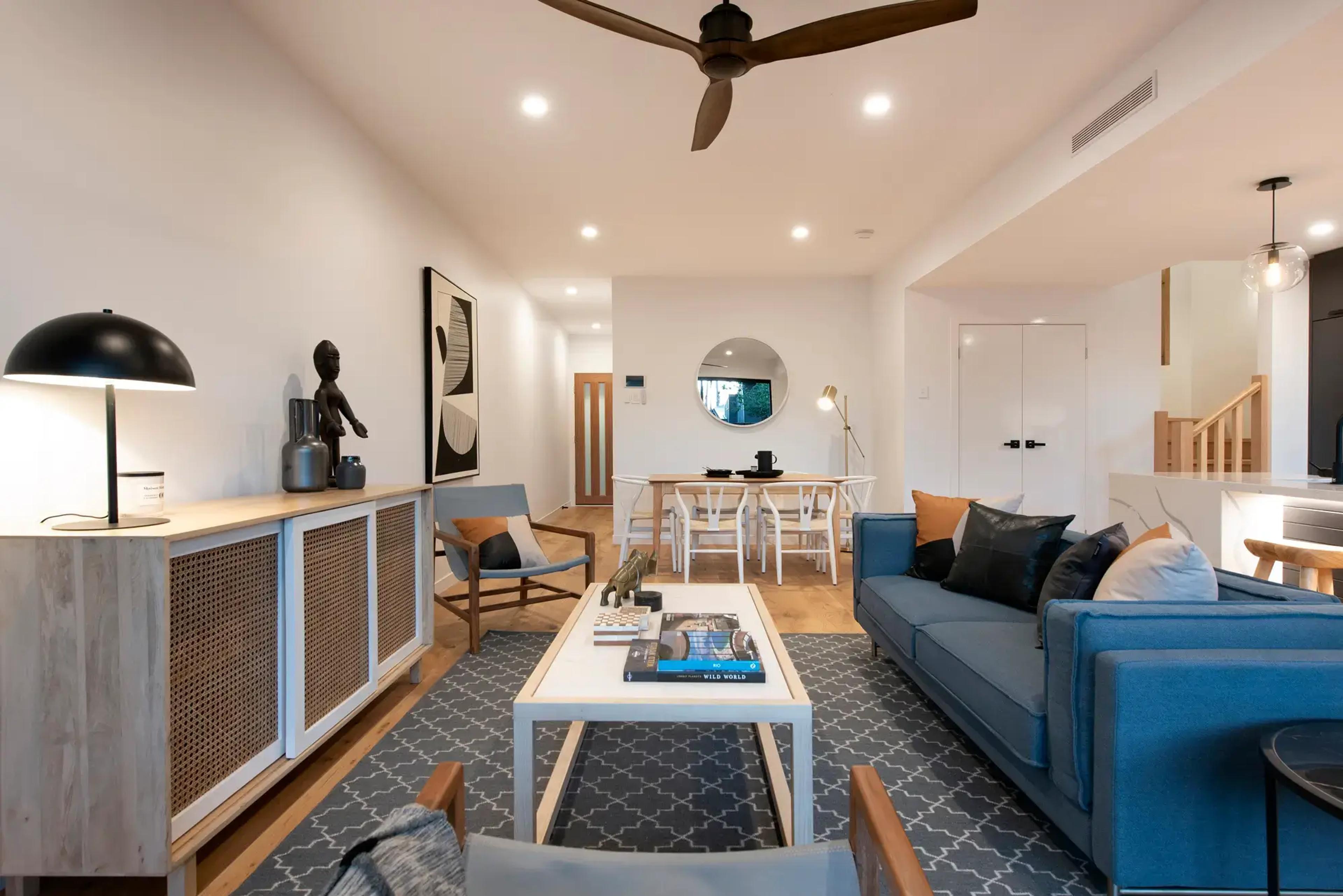 Living lounge with blue sofa and timber floors