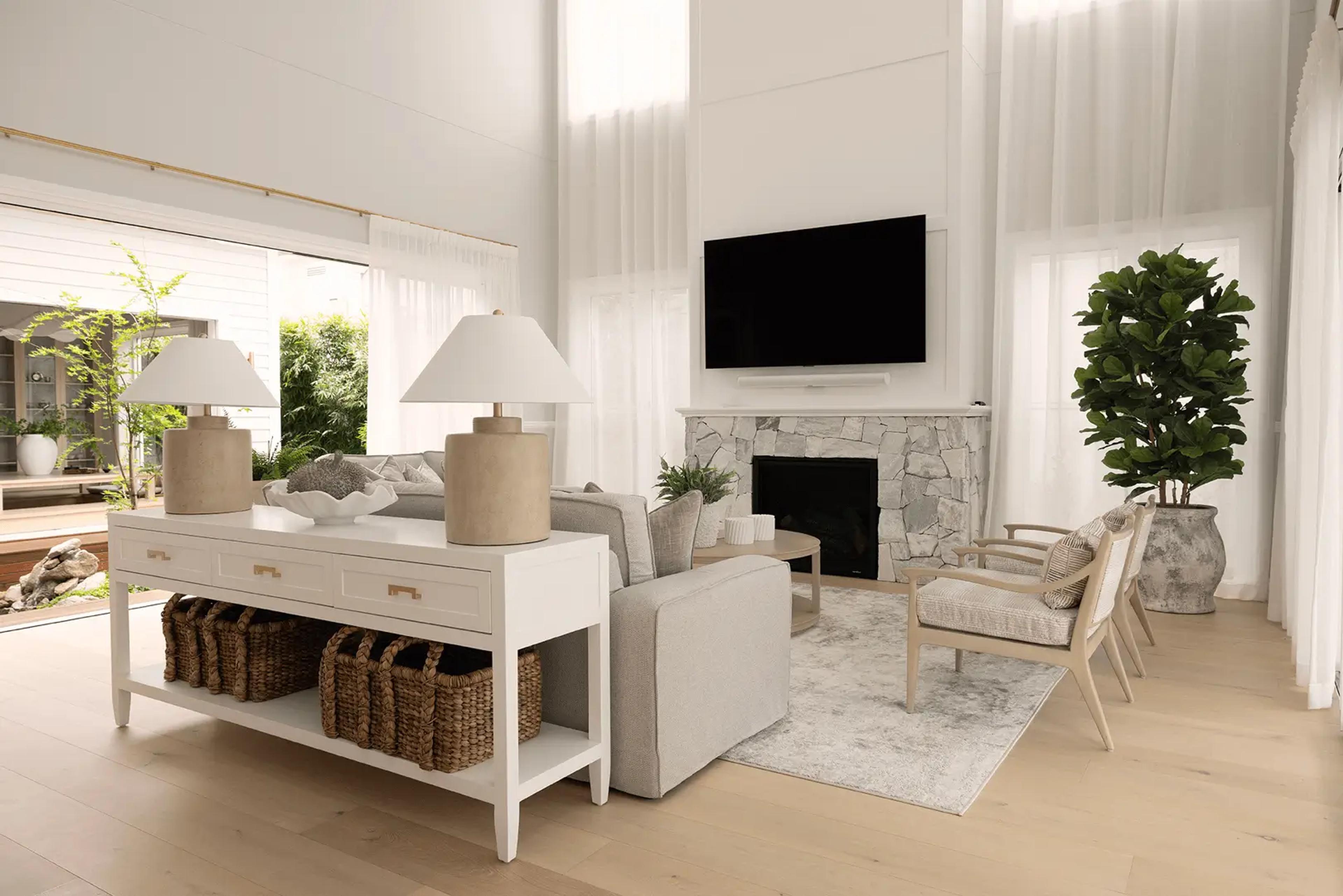 Living room with stone fireplace and sheer curtains