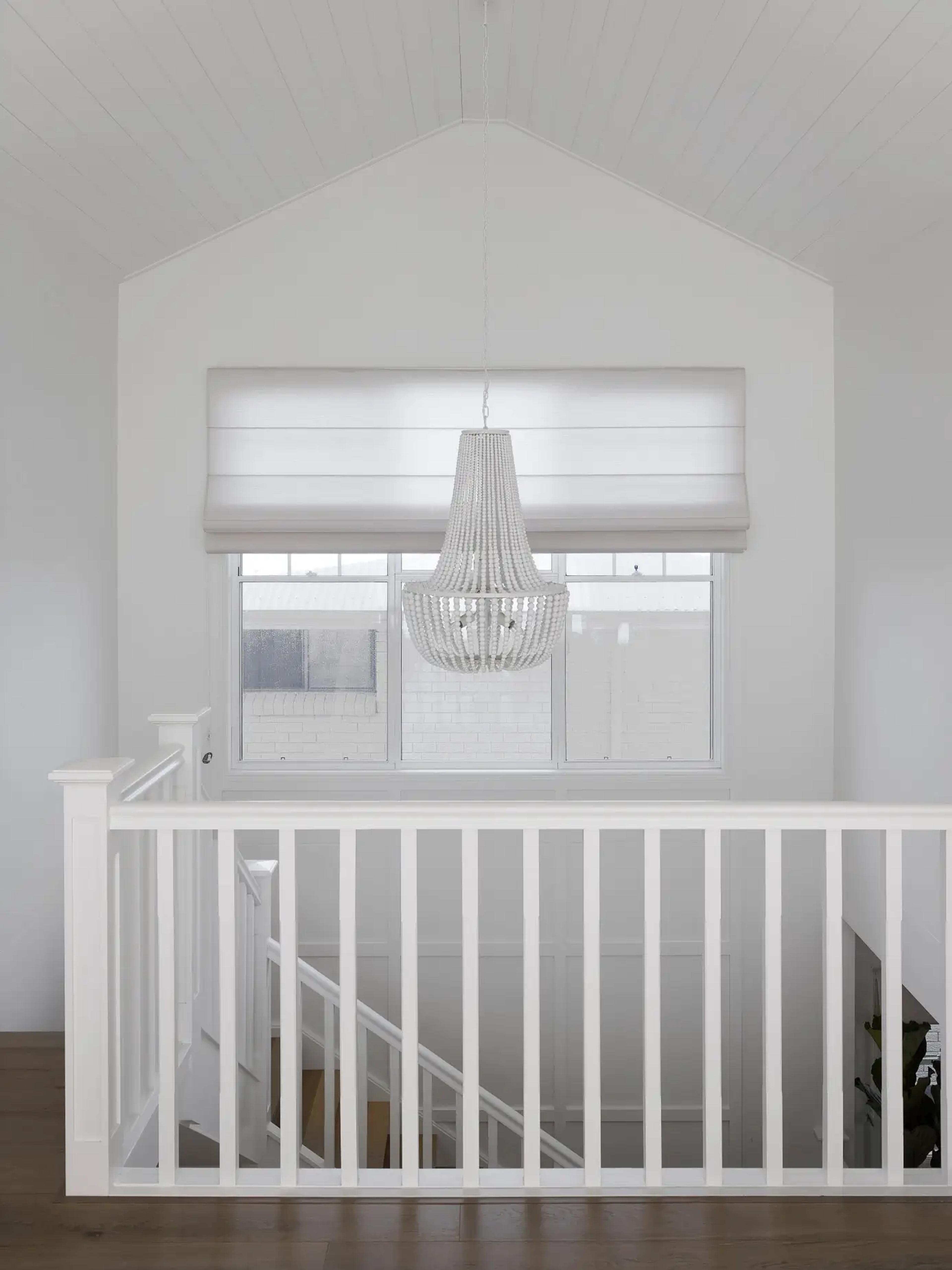 Upstairs landing with beaded chandelier and vaulted timber ceiling