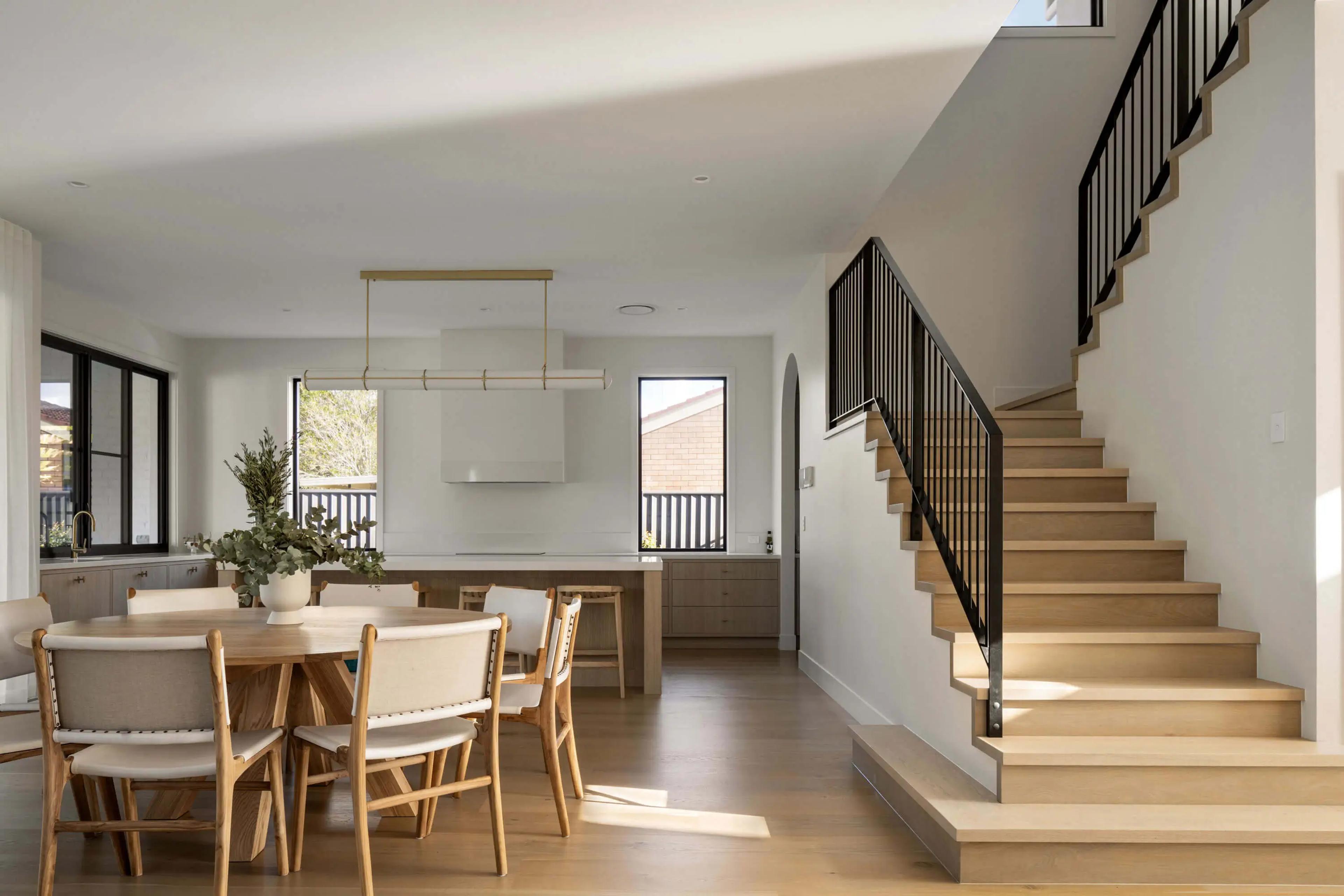 Open plan dining and kitchen with timber staircase