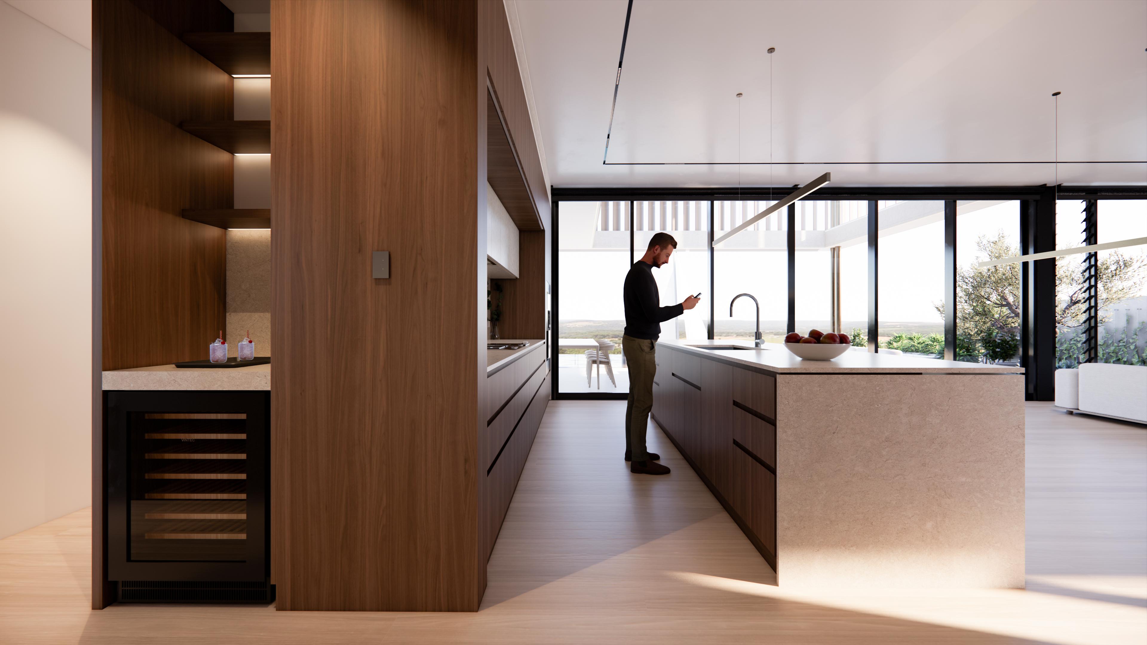 Galley kitchen with integrated wine fridge, walnut joinery and stone island framing the lake view