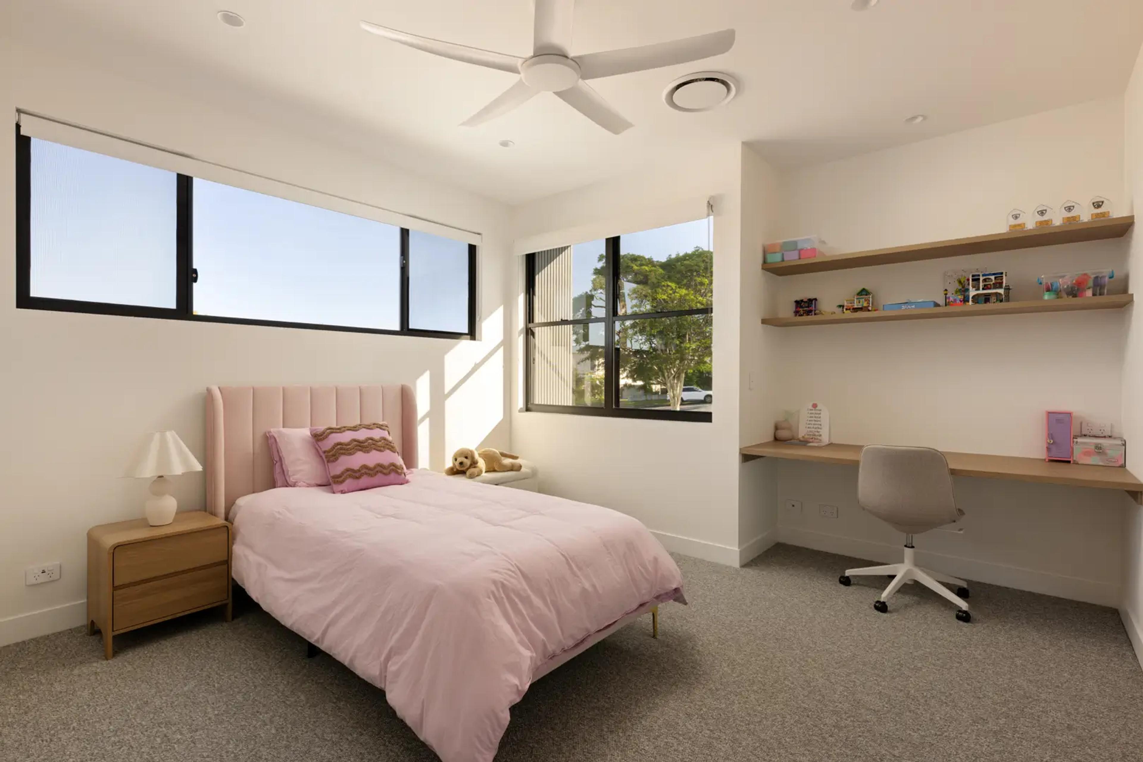 Child's bedroom with pink bed and study desk