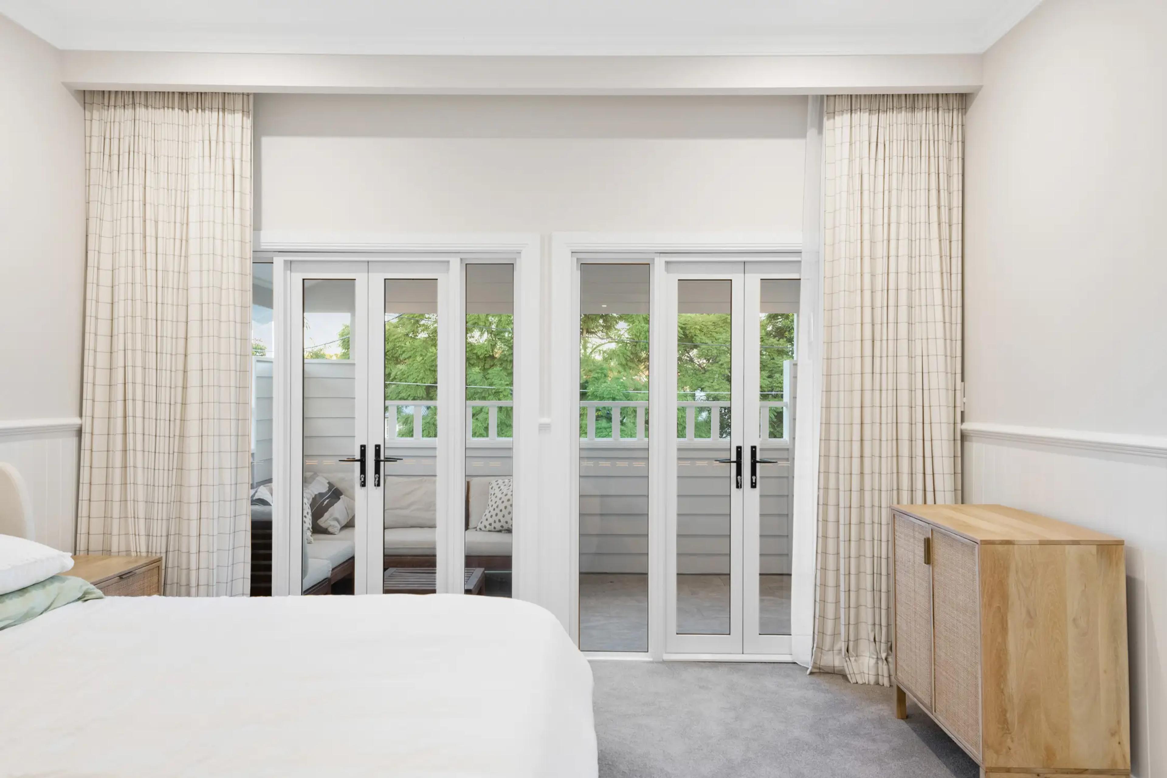 Bedroom with French doors opening to a balcony