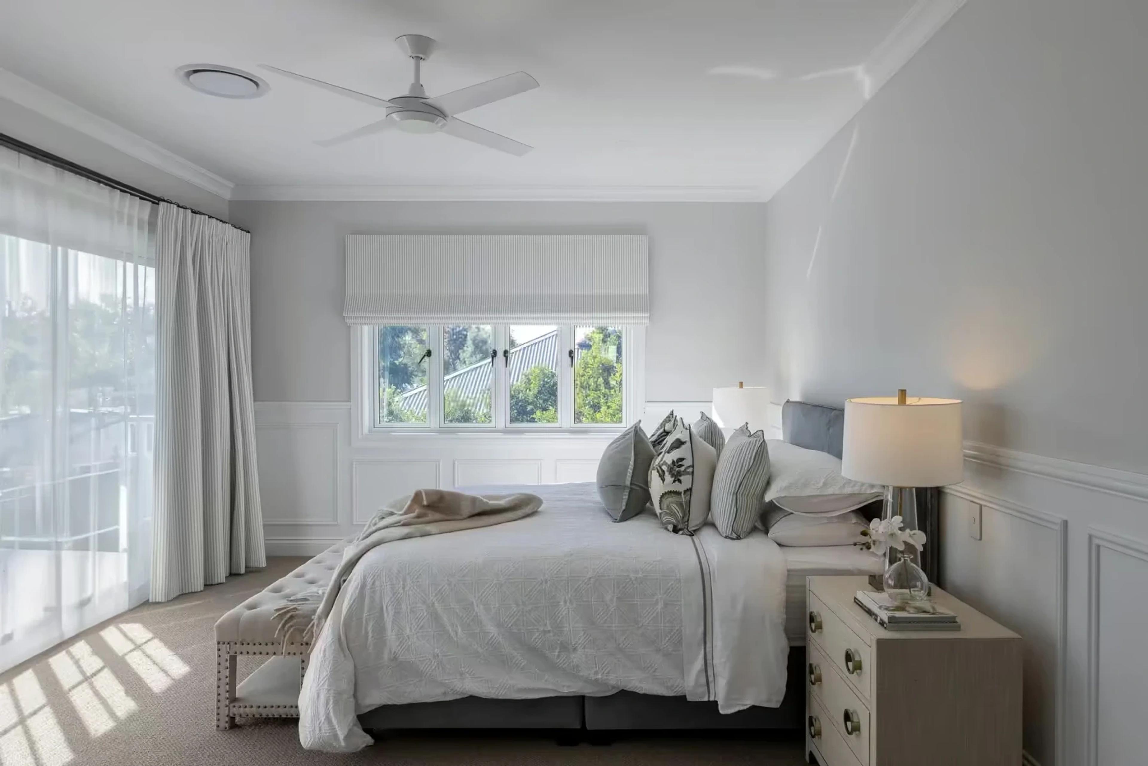 Main bedroom with grey tones and ceiling fan