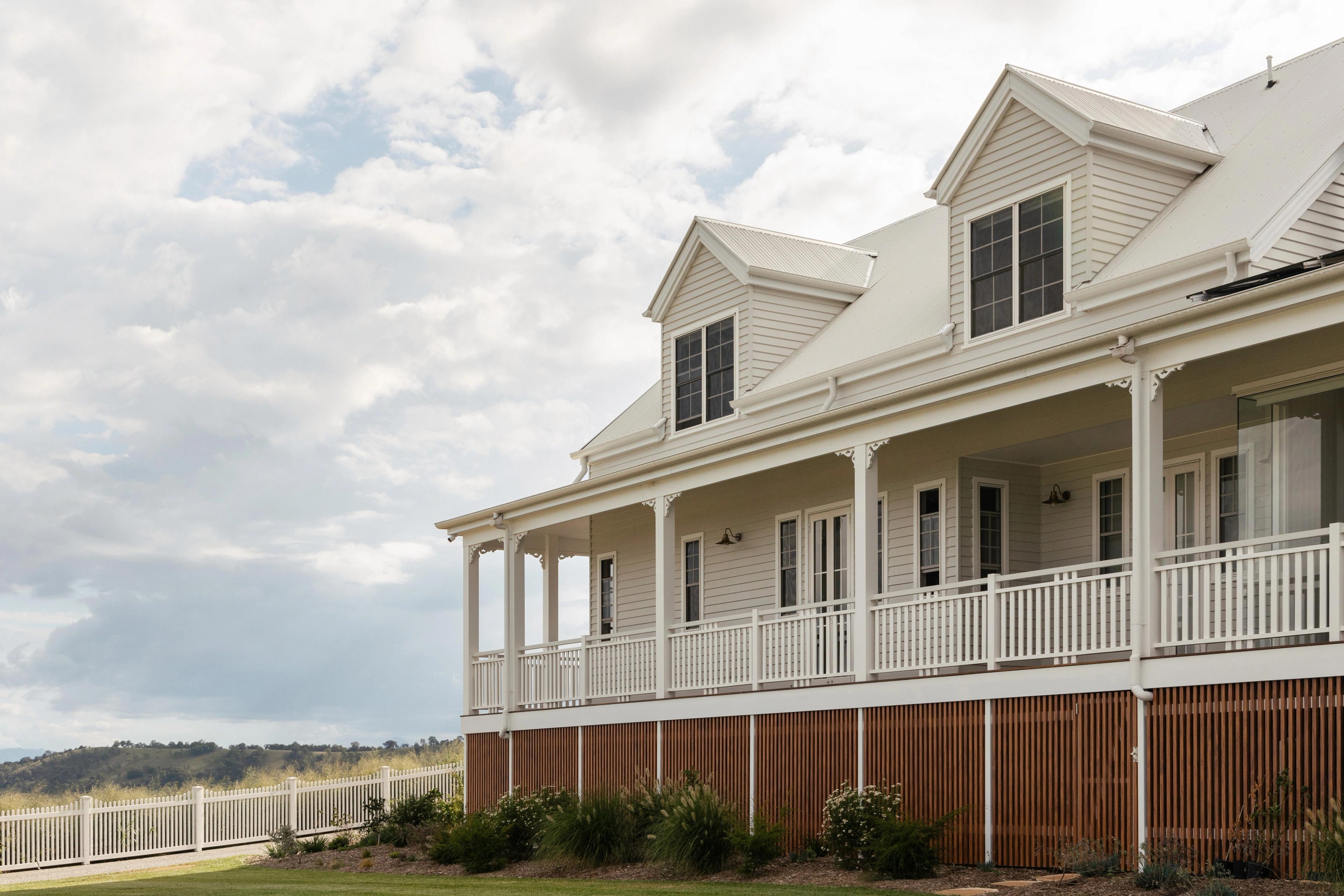 Side elevation of weatherboard home with wrap-around verandah and dormers